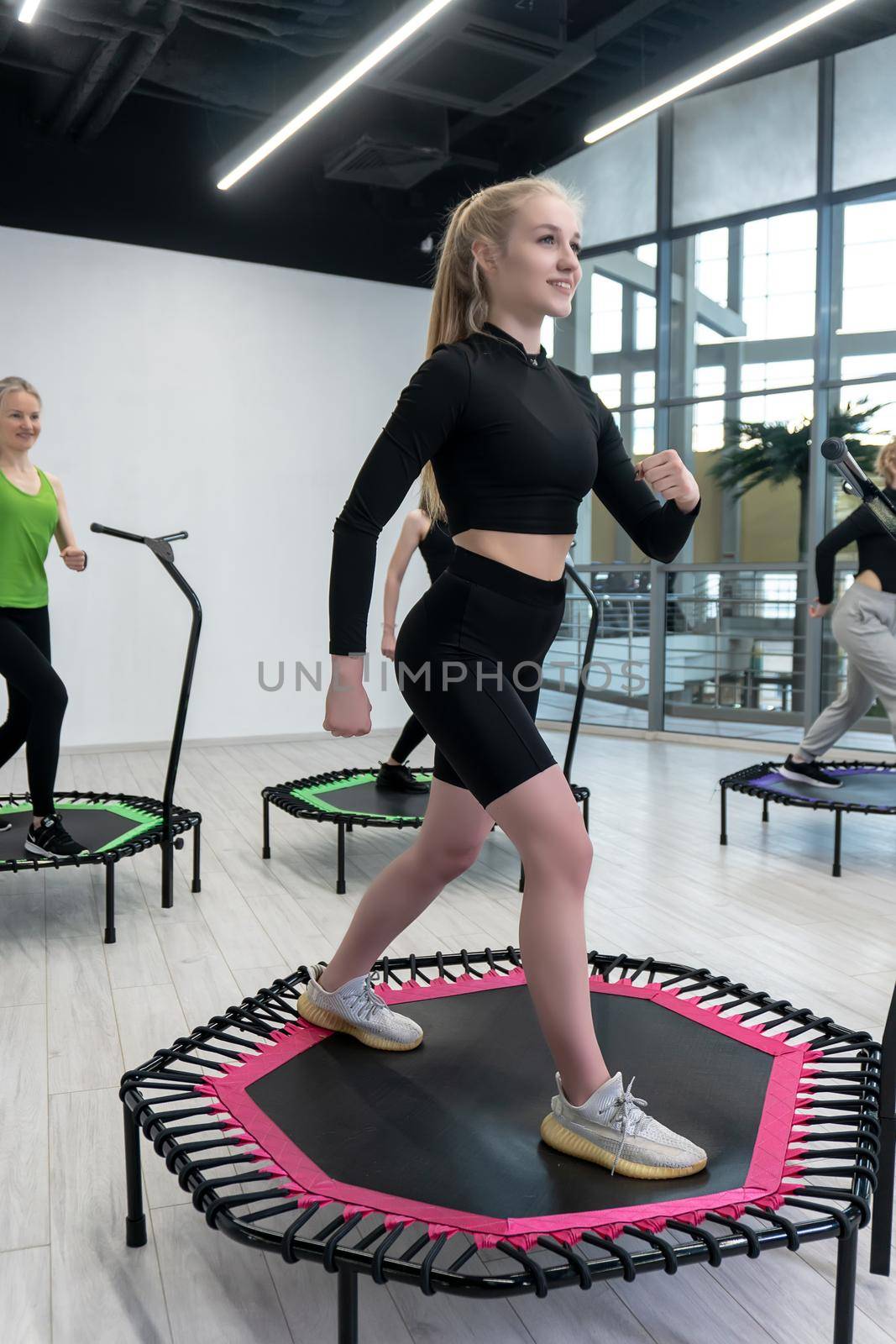 Trampoline for fitness girls are engaged in professional sports, the concept of a healthy lifestyle jumping trampoline woman fitness jump healthy, from exercise active in cardio from athletic movement, club vitality. Mini cute motion, center by 89167702191