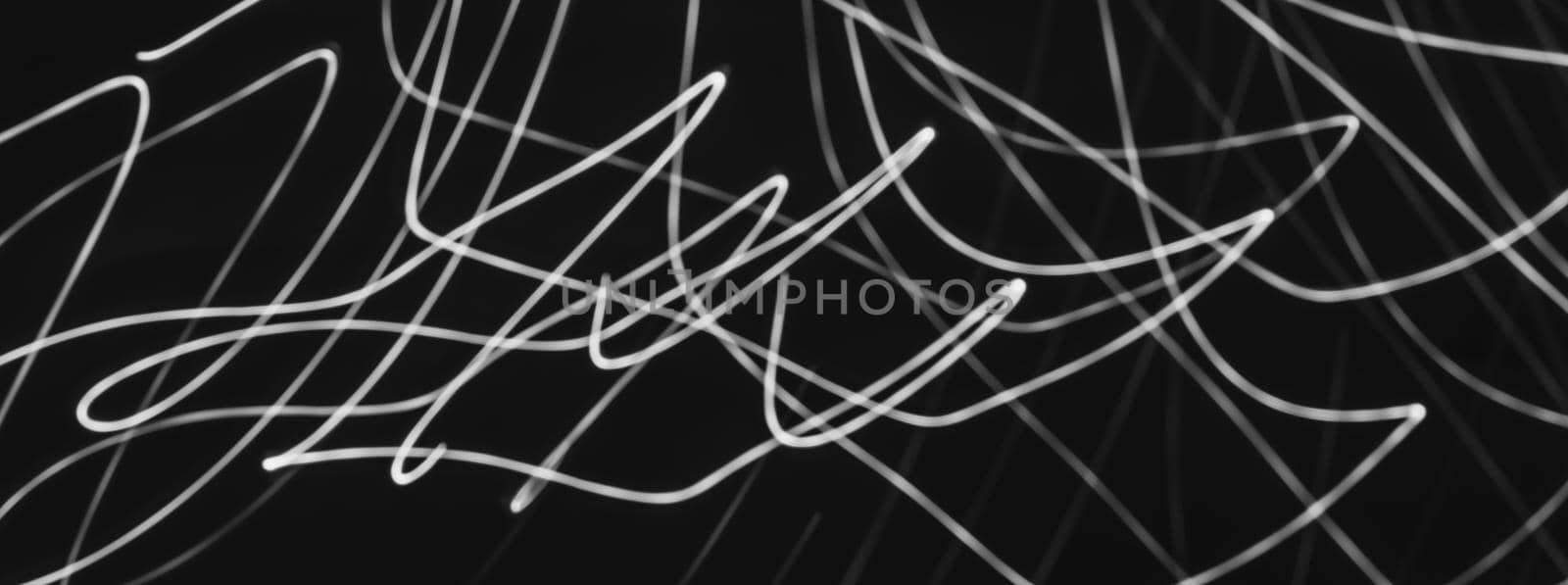 Abstract painting with white light on black. Waves and curved lines. Creativity. Photo effect.