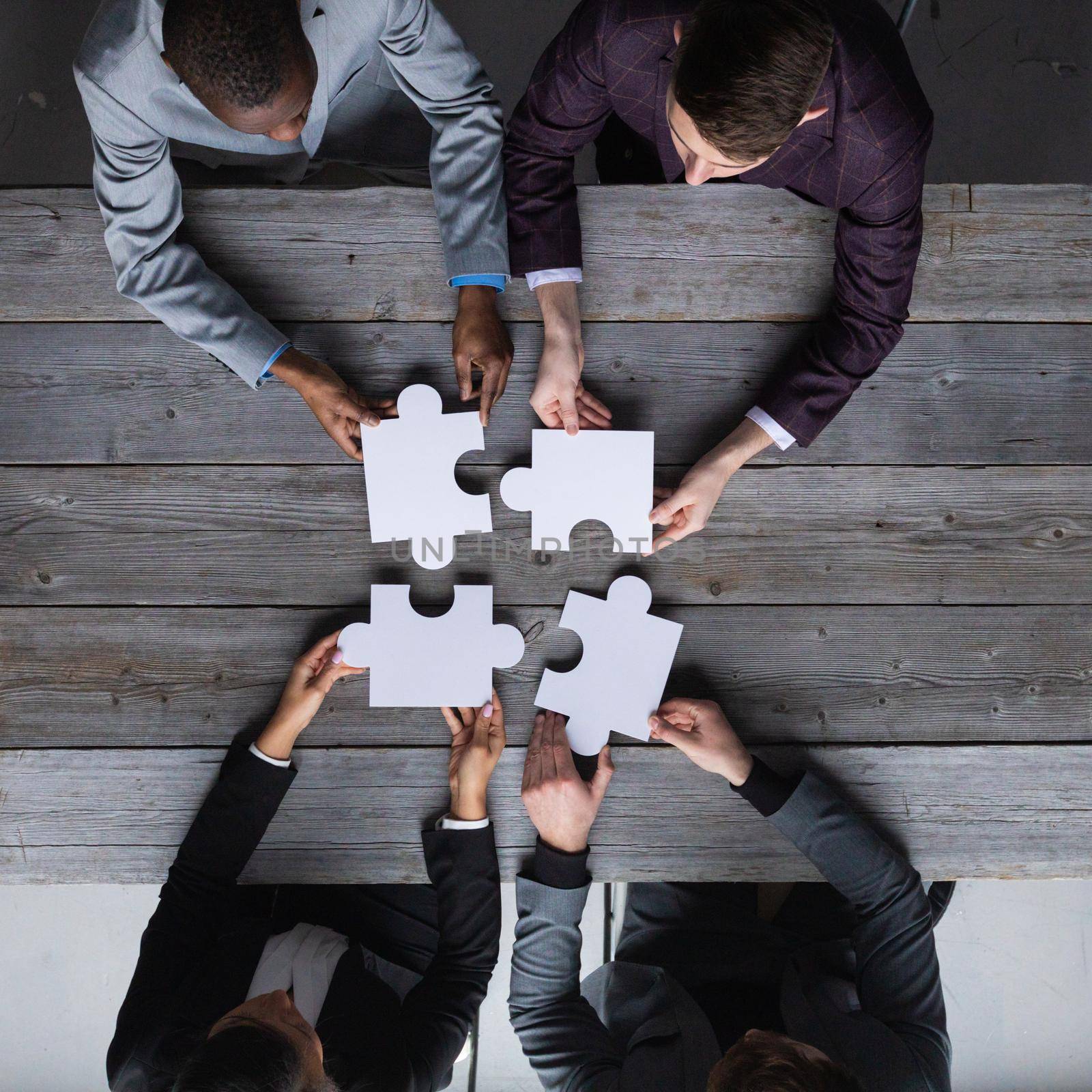 Business people assembling jigsaw puzzle by ALotOfPeople