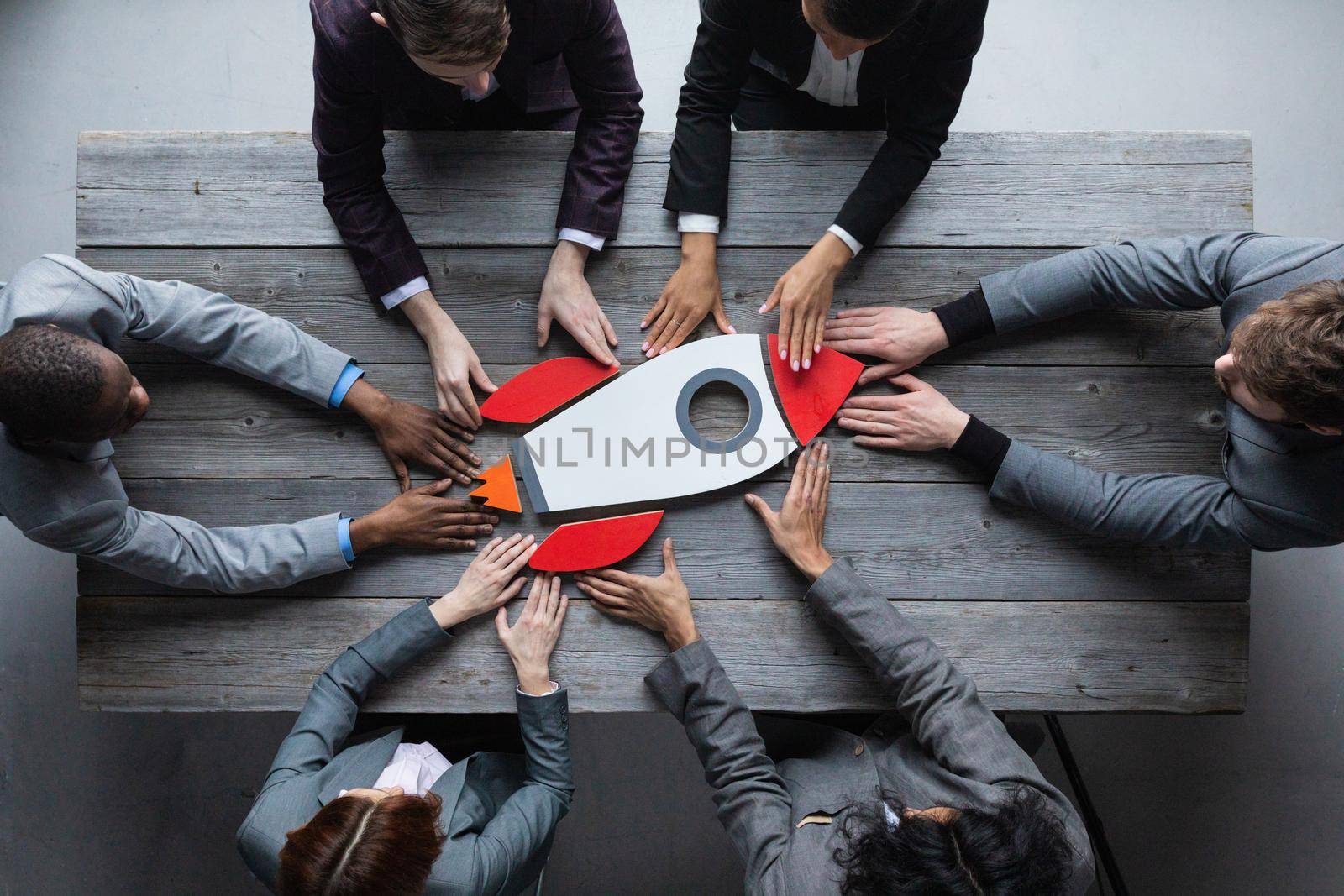 Top view of a business team members launching rocket startup success symbol concept