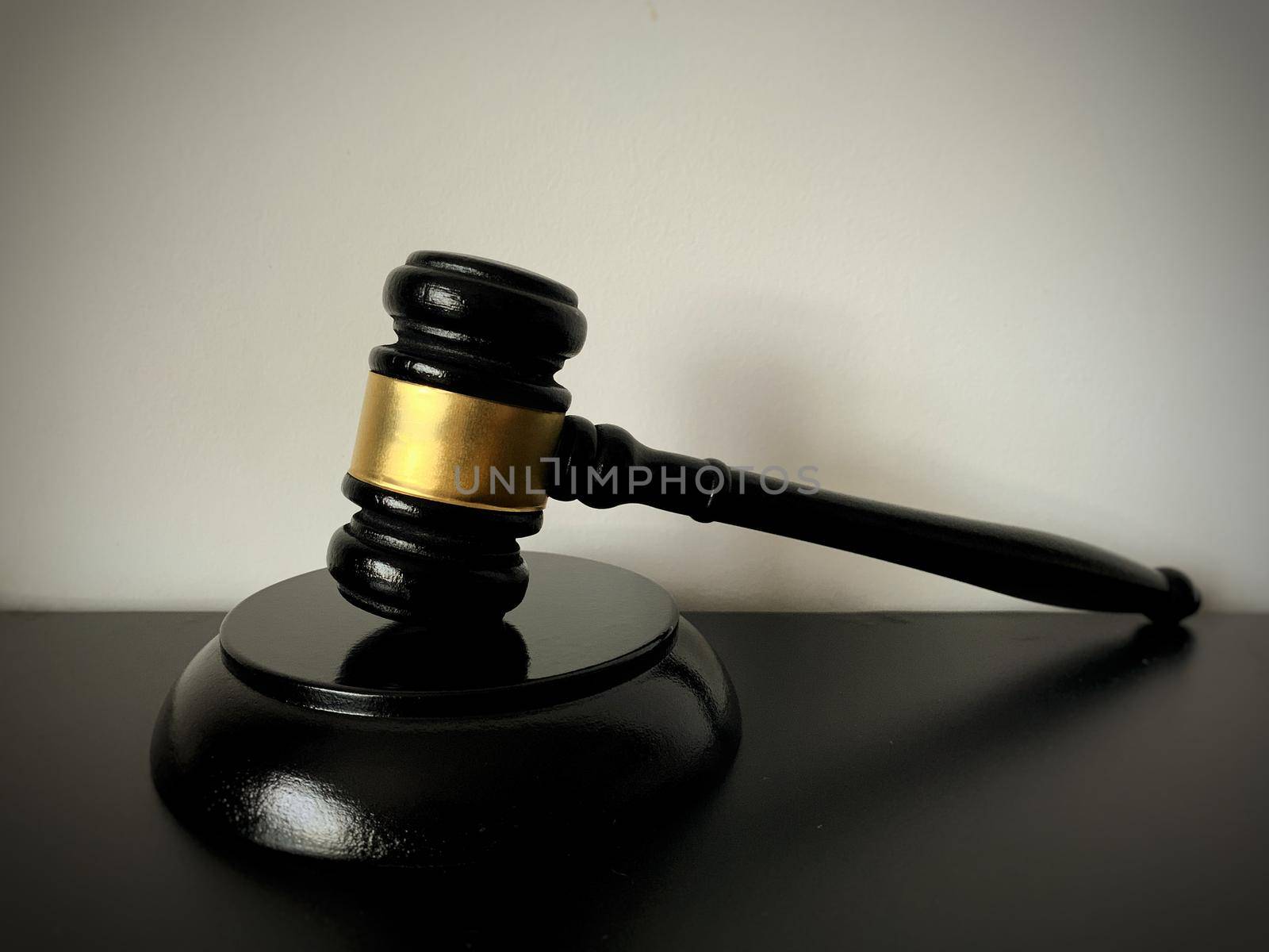 Close up of judge gavel on black table background.
