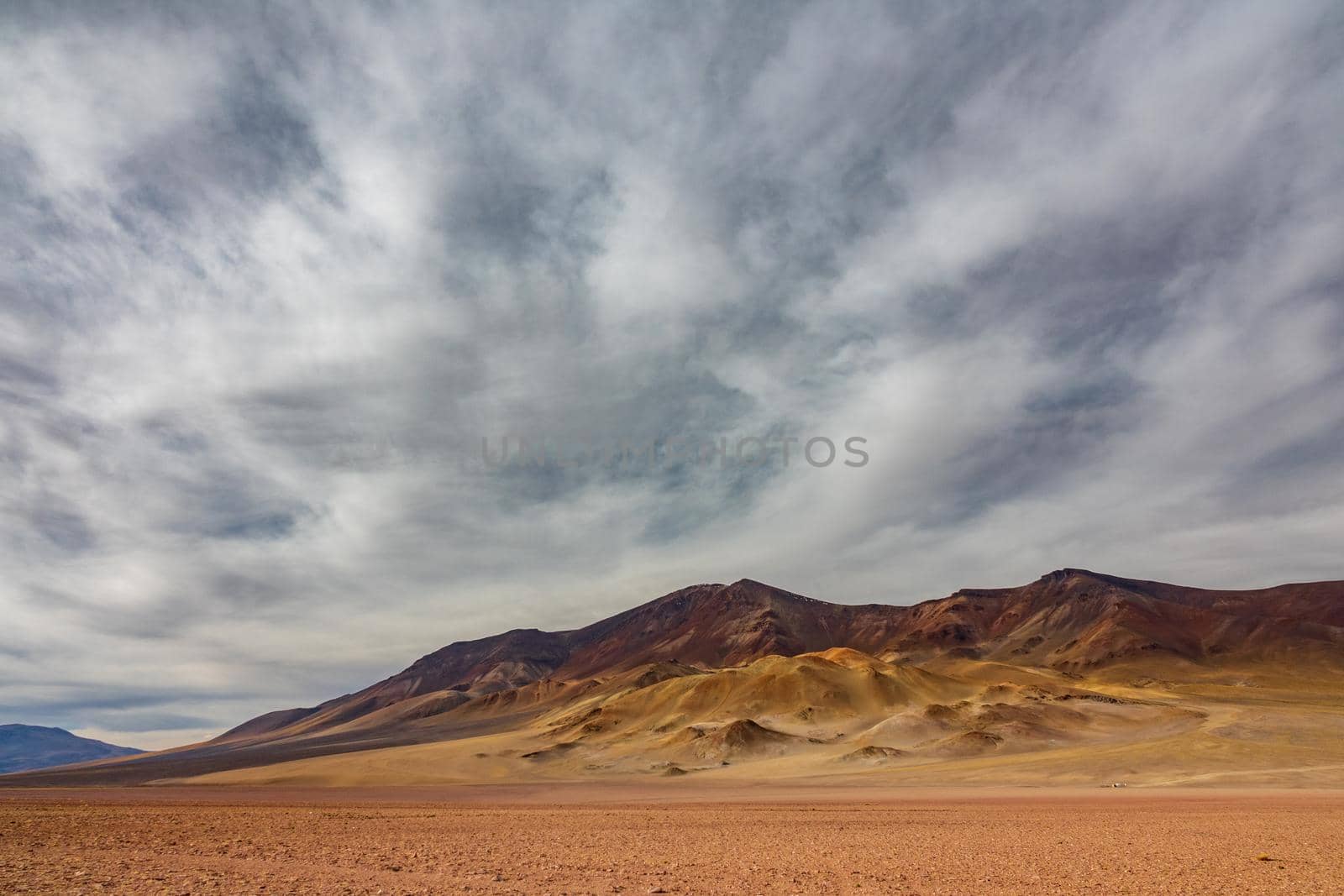 Dry mountains under the cloudscape in the desert of Atacama,Chile
