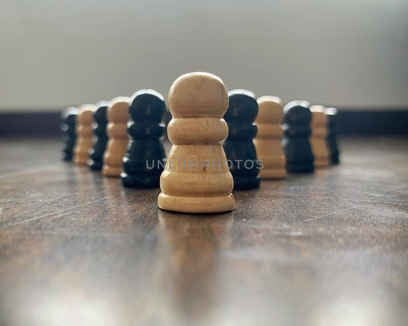 Leader with his team concept with chess pawn lining up before the leader. Leadership concept