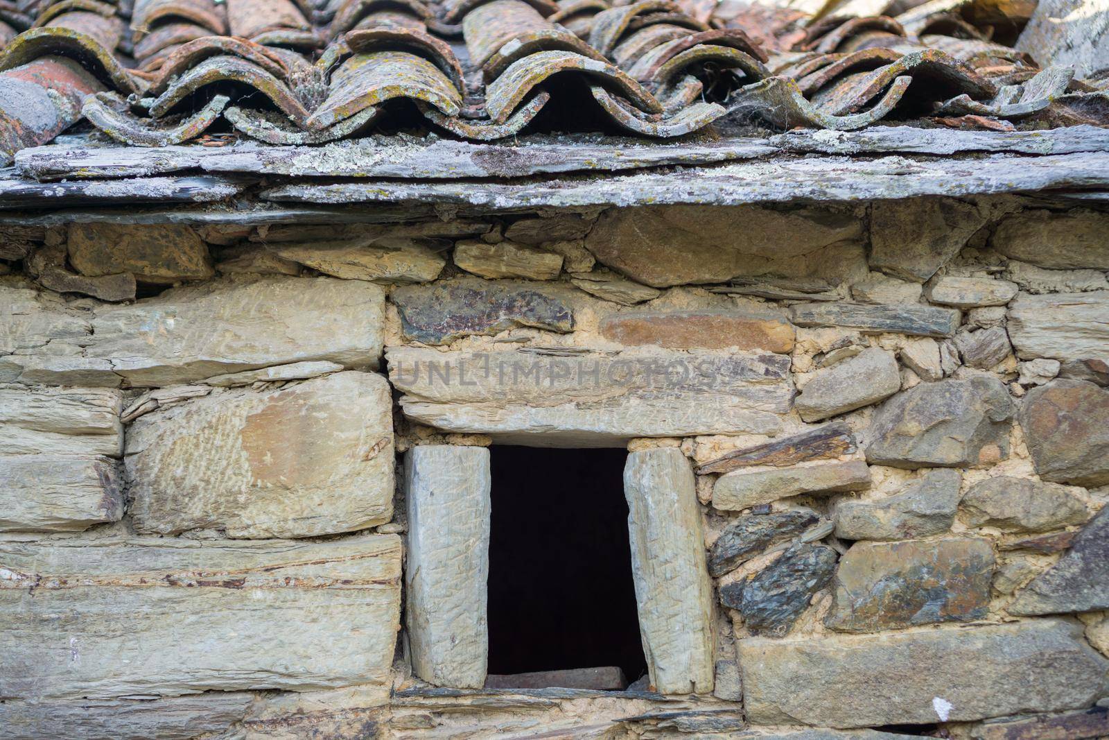 Stone wall and old window, front view