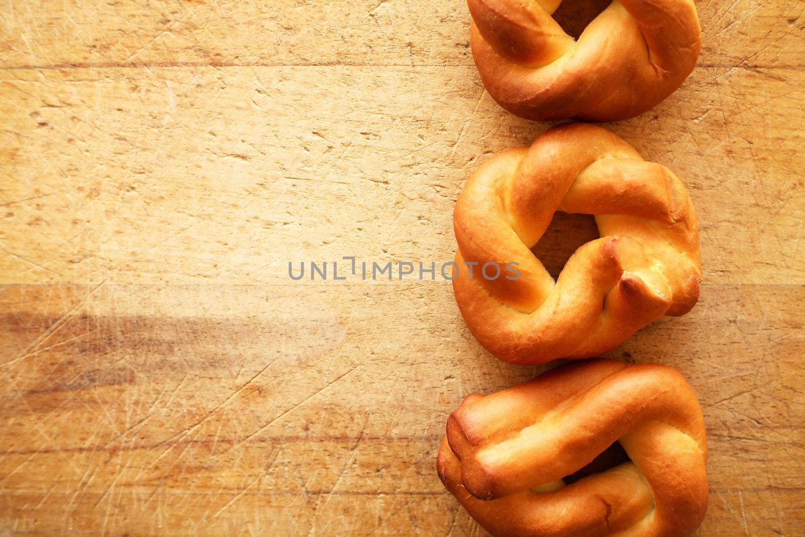 Few freshness bagels on old wooden background with free space