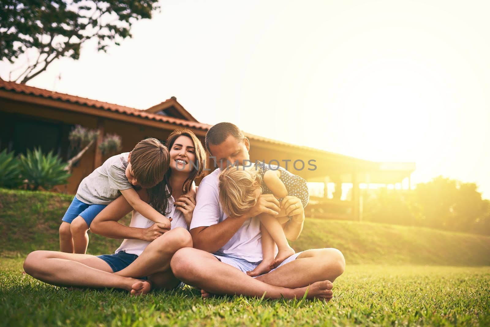 Every moment spent together is absolute bliss. Shot of a happy family bonding together outdoors. by YuriArcurs