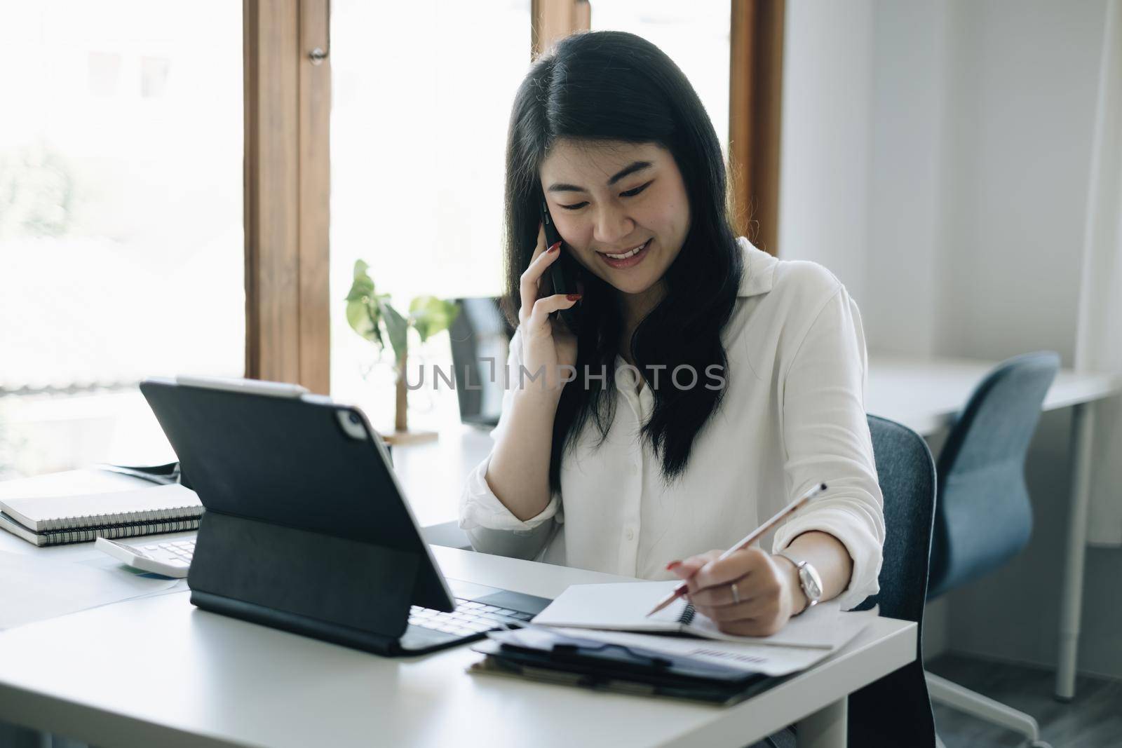 Asian Businesswoman or Accountant hands holding paperwork with calculator, account and saving concept. by itchaznong