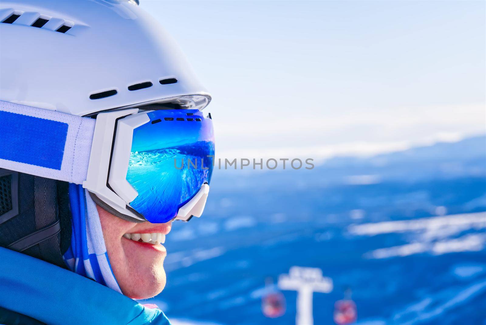 Portrait of woman in alps. woman in ski goggles at the ski resort. reflection in ski goggles by PhotoTime