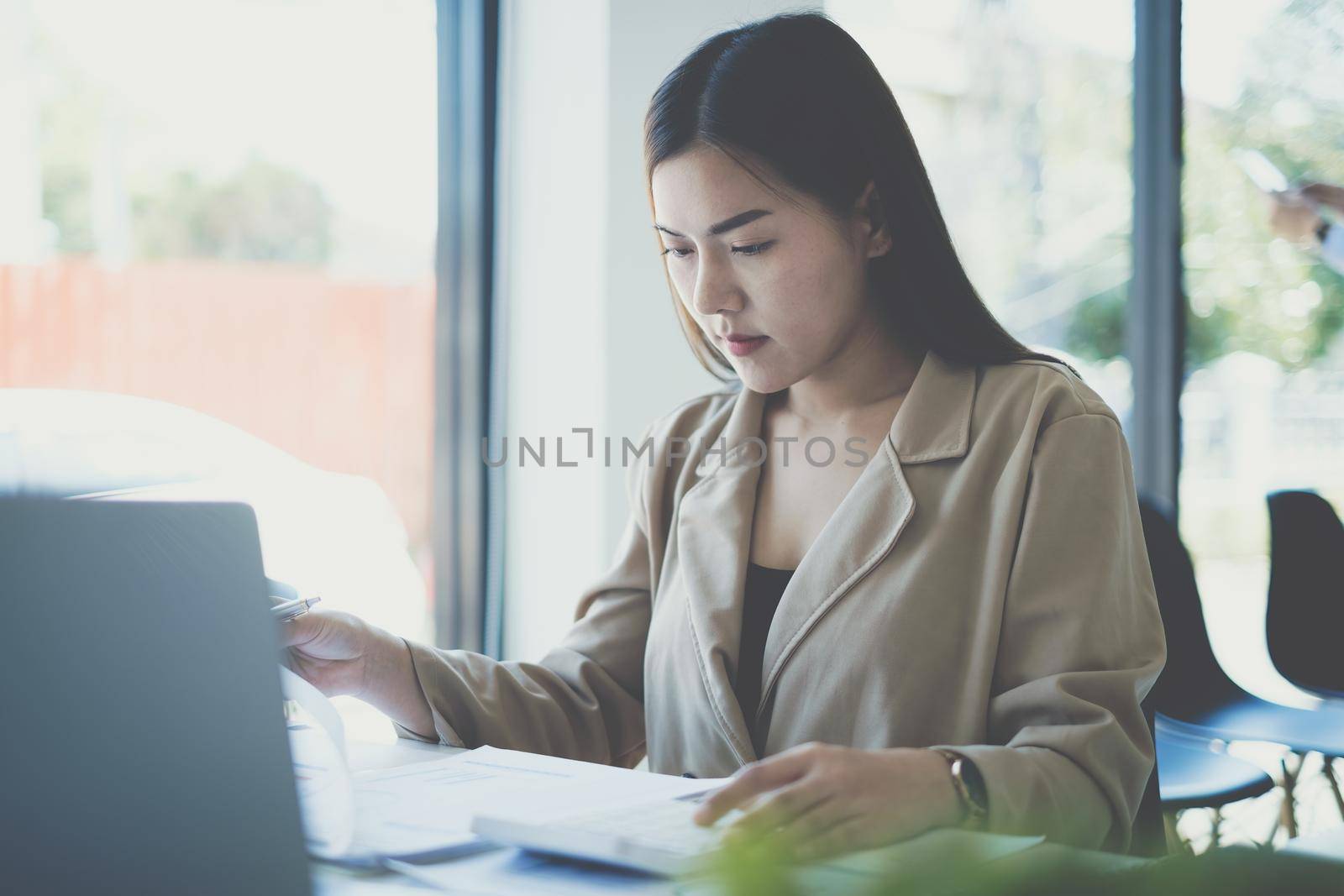 Portrait of Busy Asian Secretary waiting customer while working at office. Business Finance concept