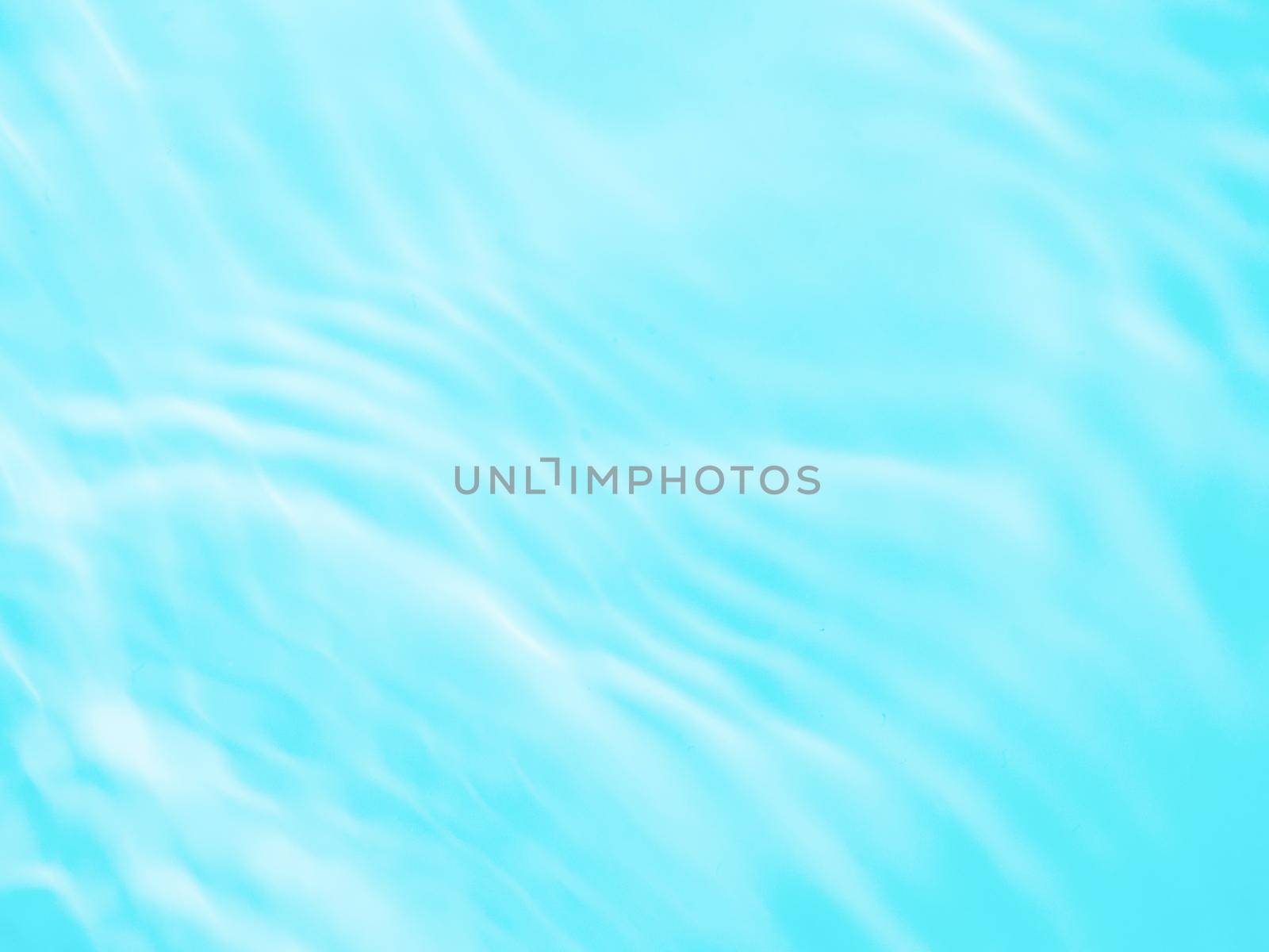 Ripple water texture on blue pool background. Shadow of water on sunlight. Mockup for product, spa or travel background. Marble blue water surface as wallpaper background