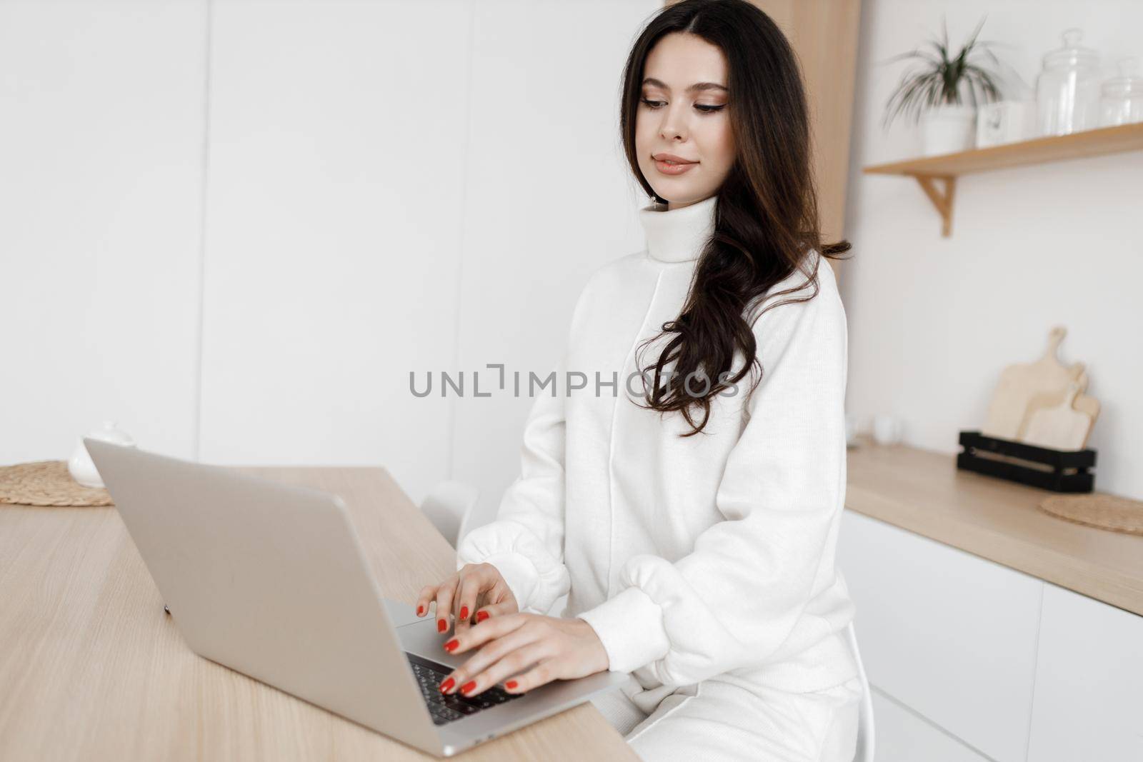 young cozy woman working in laptop by splash