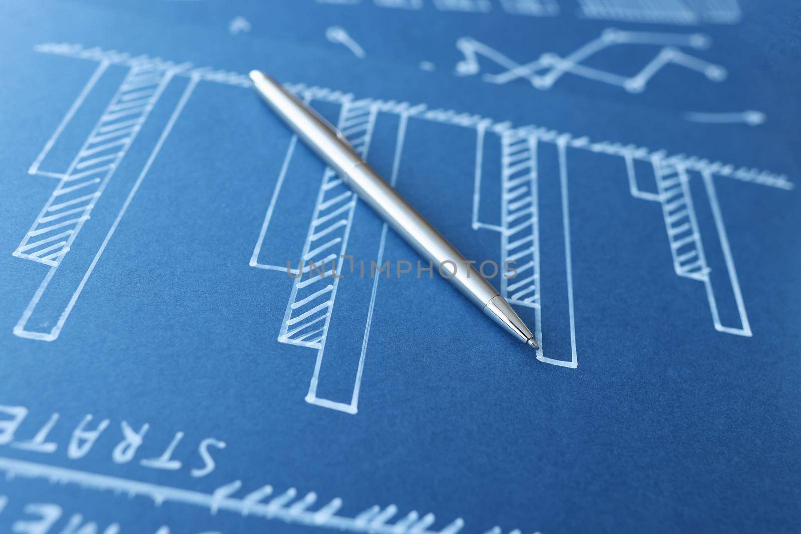 Ballpoint pen lying on blue document with graphs closeup. Profit growth in business concept