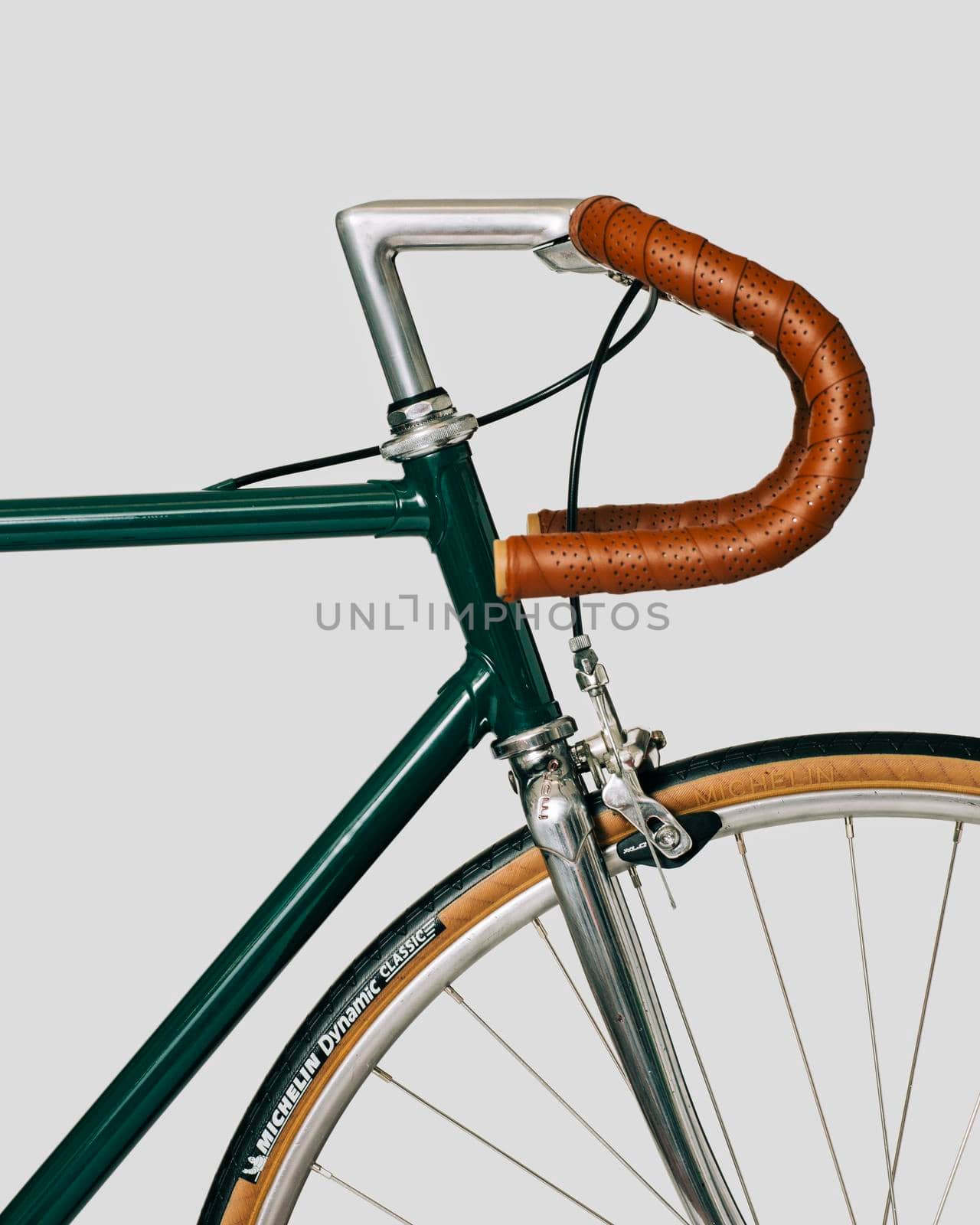 Vintage classic bicycle, with leather tape and saddle. White background. High quality photo