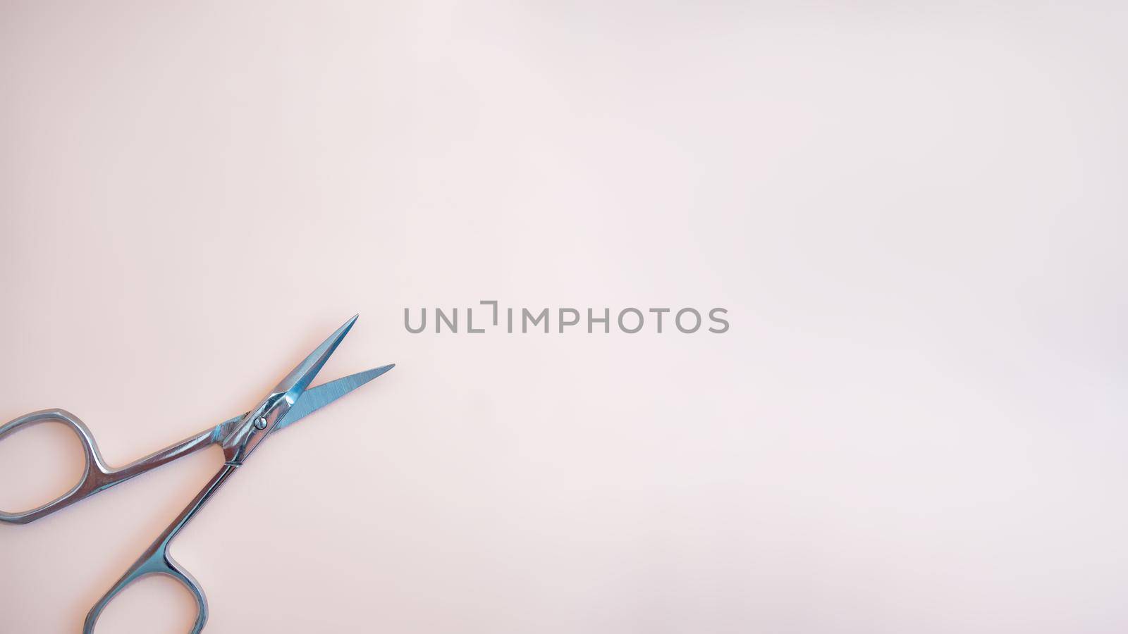 A set of cosmetic tools for manicure and pedicure on a pink background. Gel polishes, nail files, manicure scissors. photo