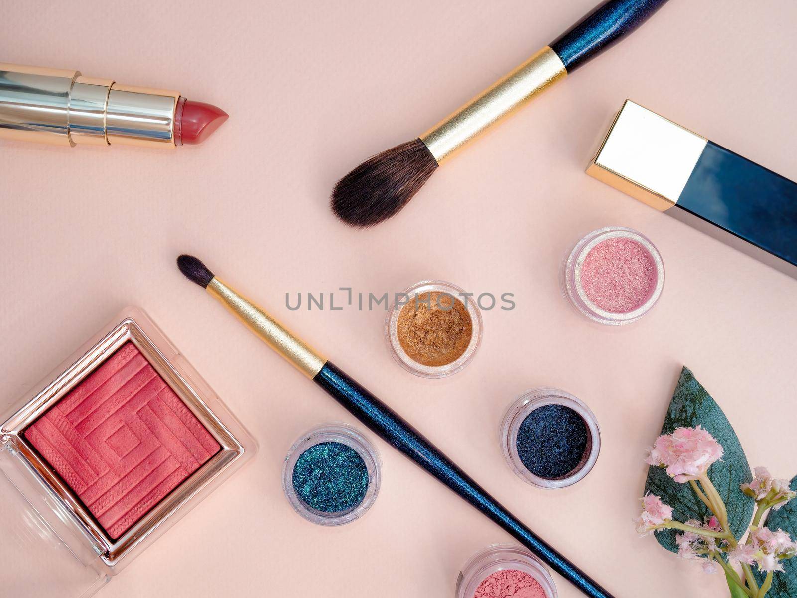 set of beauty cosmetics for female face and eye makeup on pink background . photo