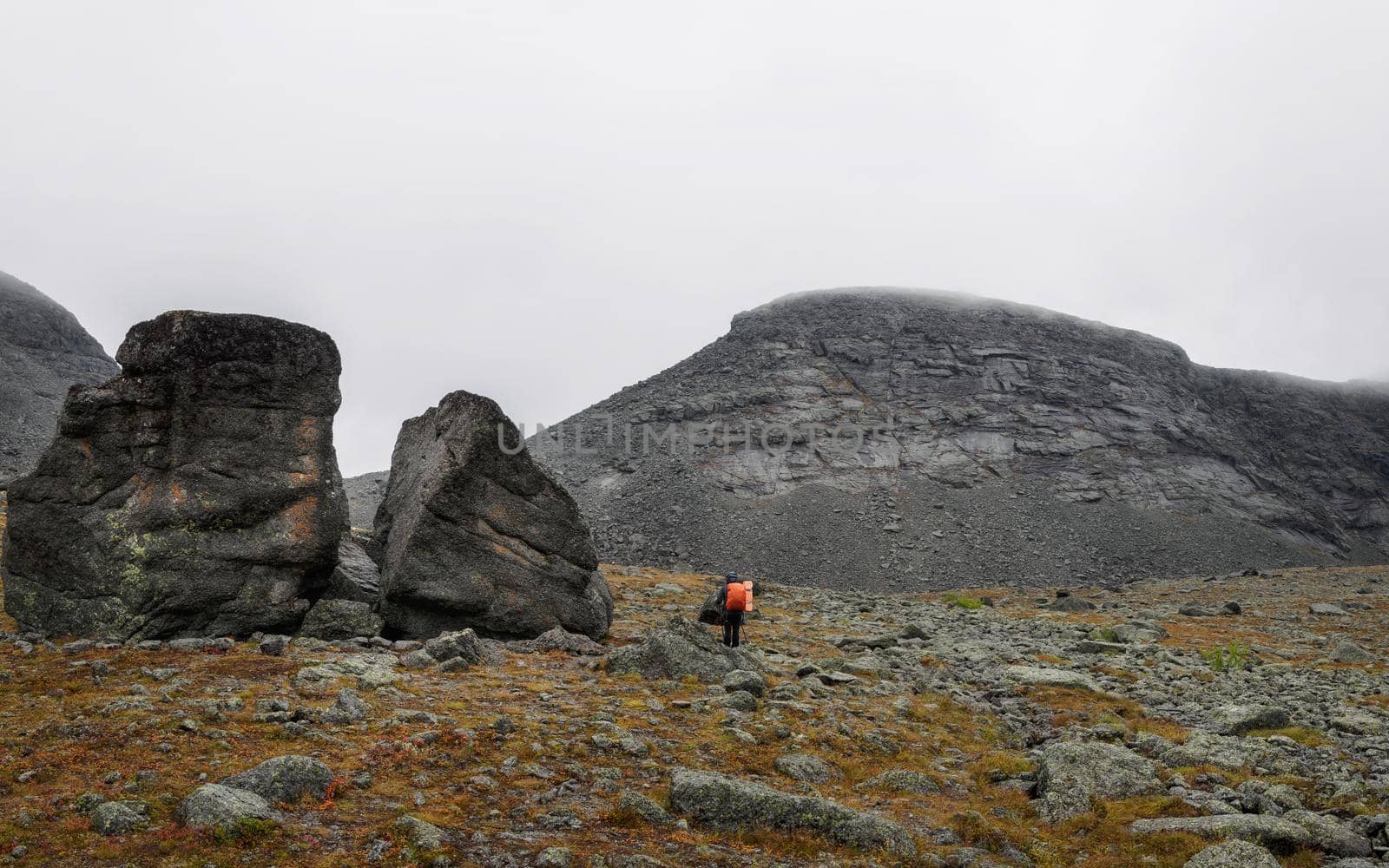 Hiker woman walking in a mountain rocky path. photo