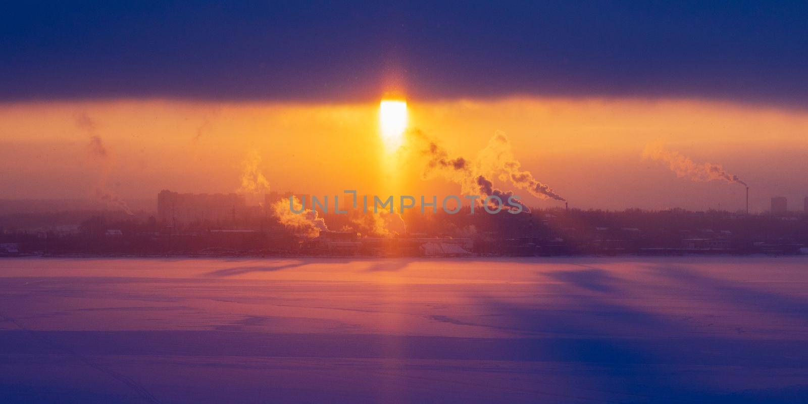 Chimneys of a factory with smoke and steam on a red sunset in the background. by Andre1ns