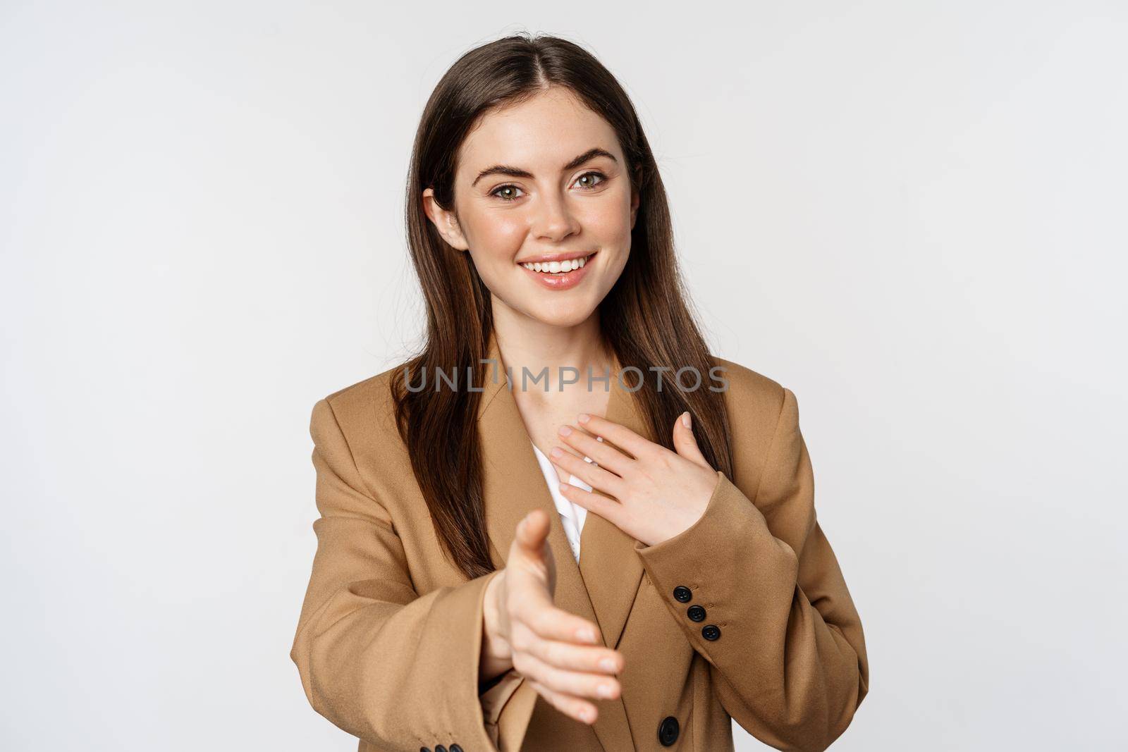 Portrait of smiling businesswoman extend hand for handshake, greeting business partner, saleswoman welcome client, white background.