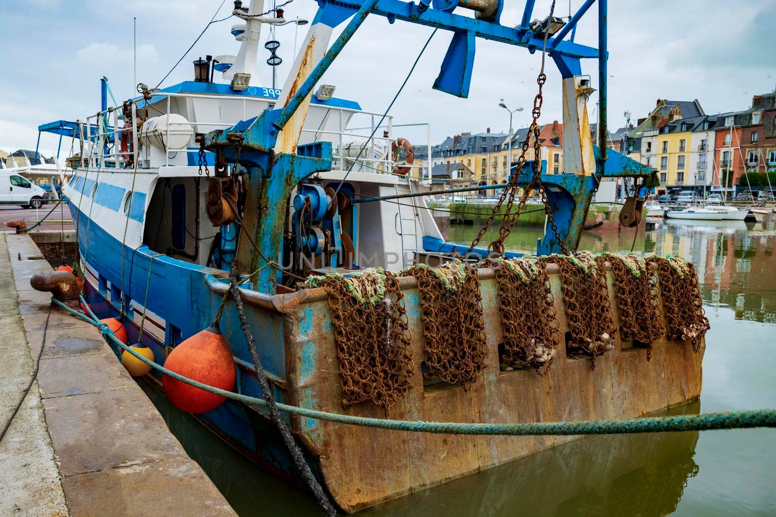 Rusty boat and metal nets for catching scallops