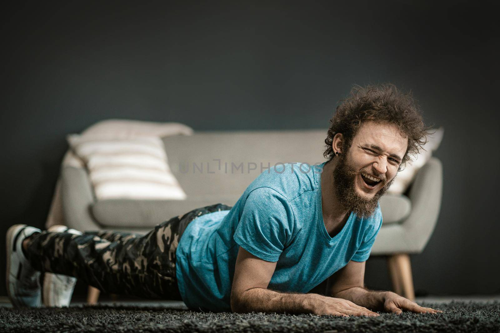 Lazy Guy Does Plank The Last Seconds. Lazy Man Does Plank With Funny Face. Medium Close-up by LipikStockMedia