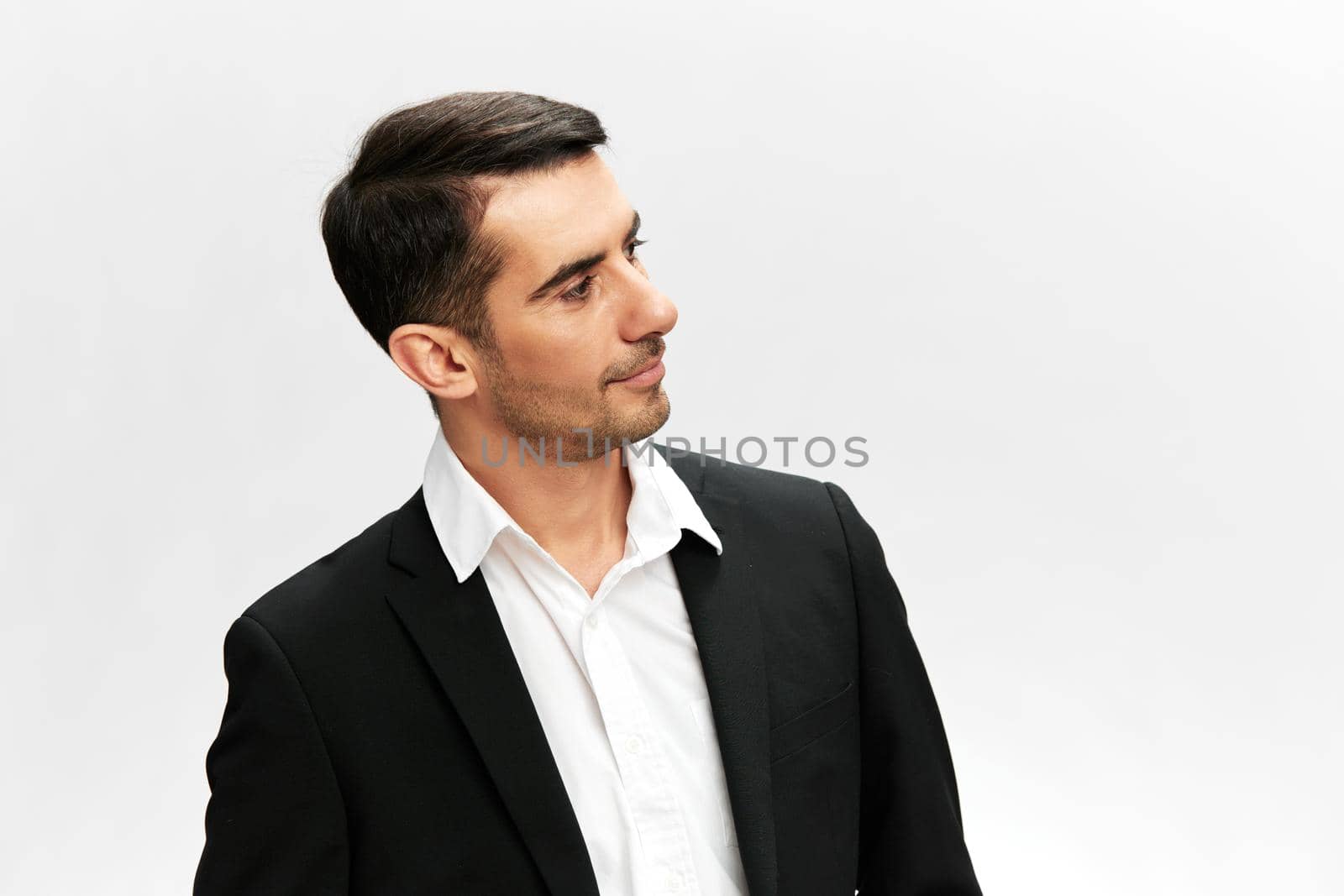 handsome businessman looking away emotion self-confidence official light background by SHOTPRIME