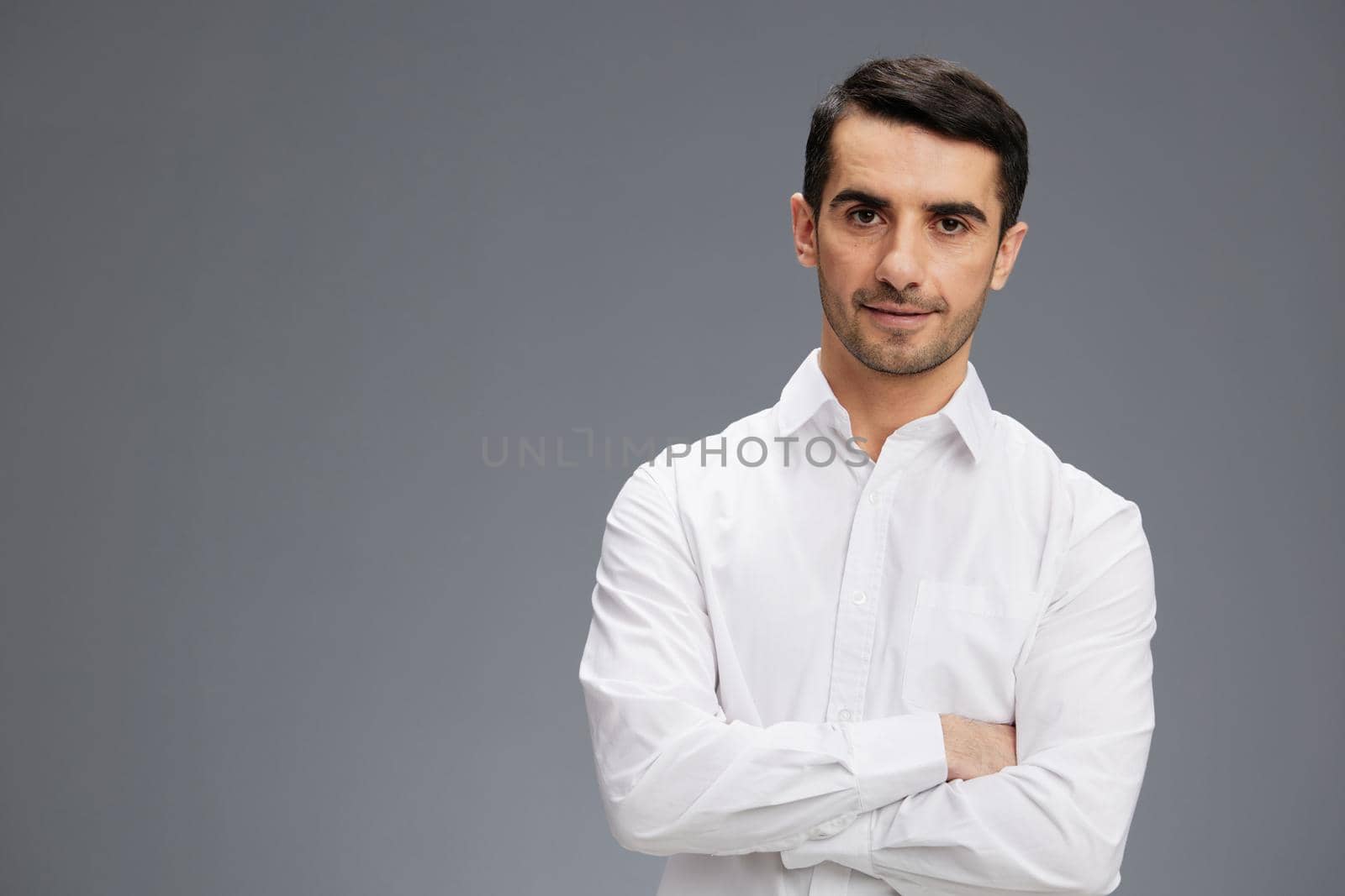 handsome businessman in a white shirt a pensive look business and office concept by SHOTPRIME