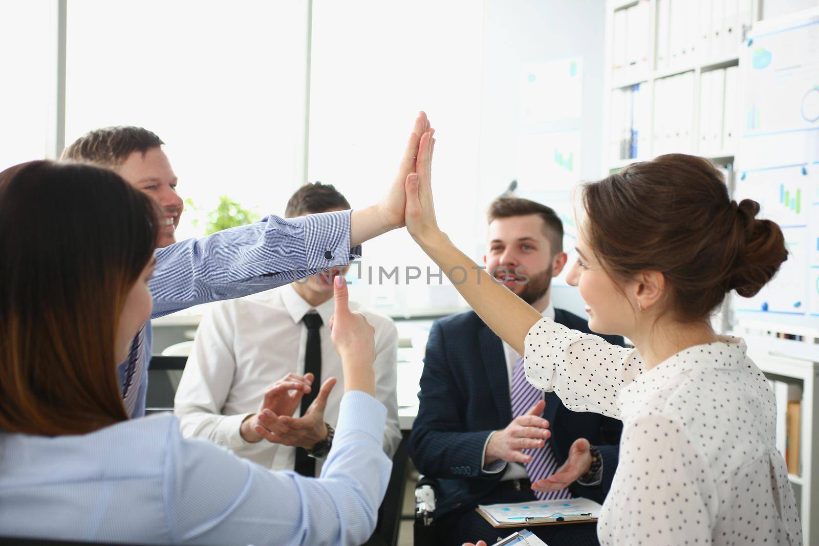 Portrait of colleagues give high five gesture in order to celebrate end of company project, change future of corporation. Goal, success, career concept