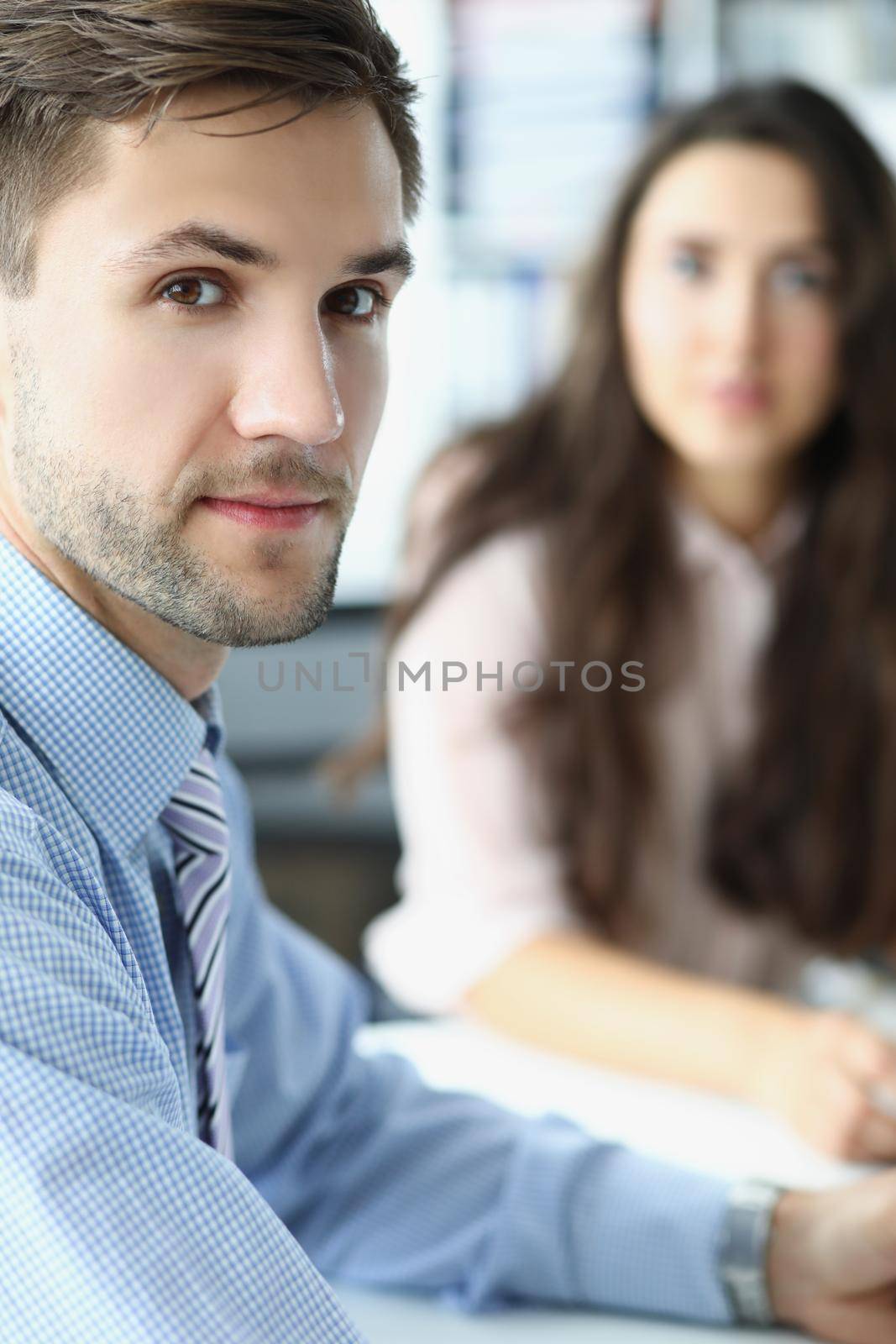 Portrait of concentrated business employee at workplace look in camera with female colleague. White collar worker at workspace. Business, meeting concept