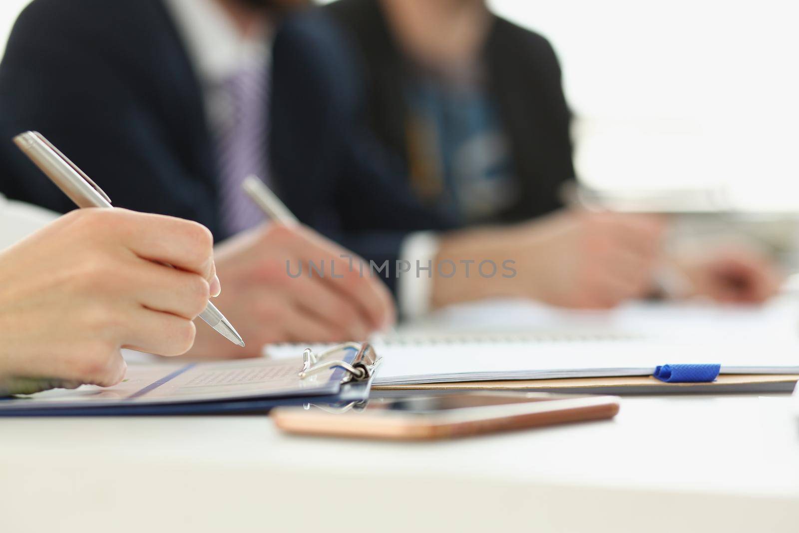 Close-up of people on conference writing down ideas in diary, notes for project. Go through real steps for progress in work. Career, strategy, idea concept