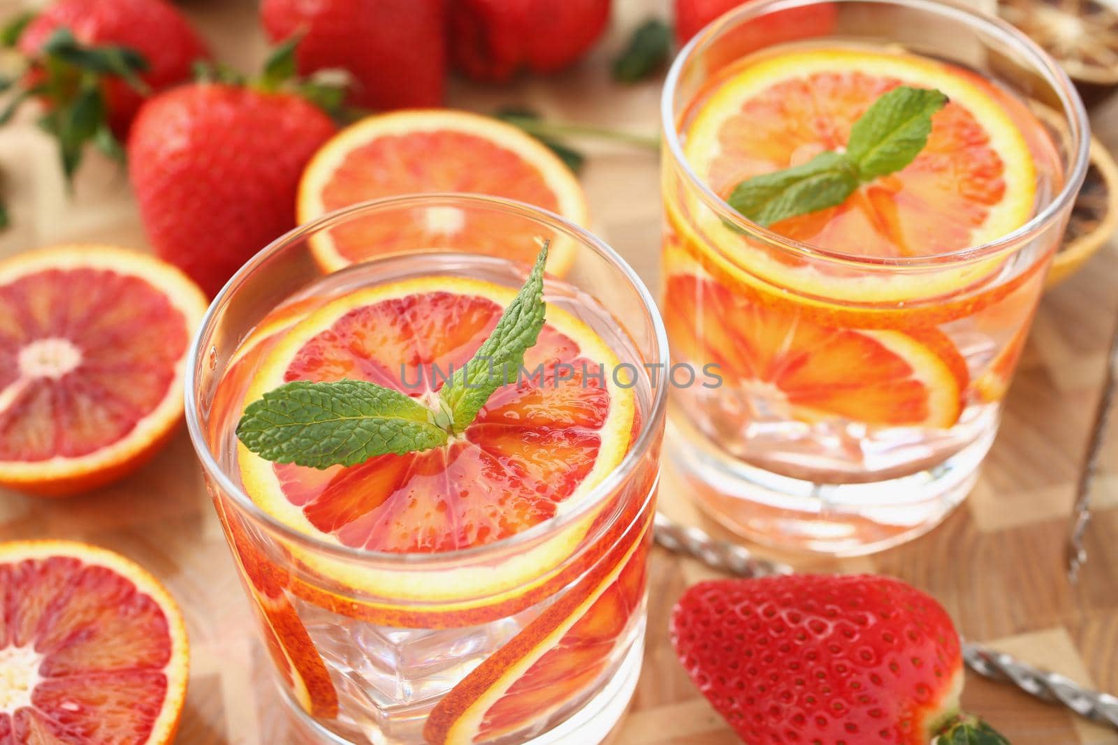 Close-up of cooling drinks cocktails in glasses, grapefruit with mint, cheers or toast. Summer fruit beverages for company. Party, harvest, vitamin concept