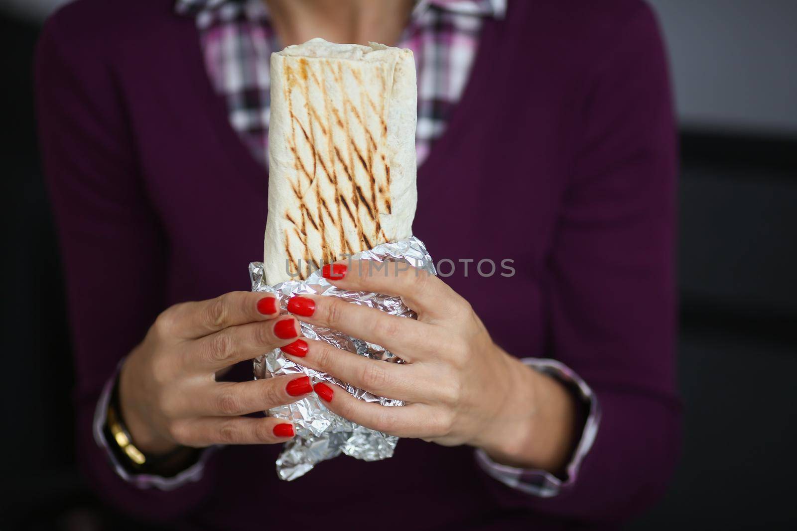 Woman hold delicious shawarma snack during work, young female with red manicure by kuprevich