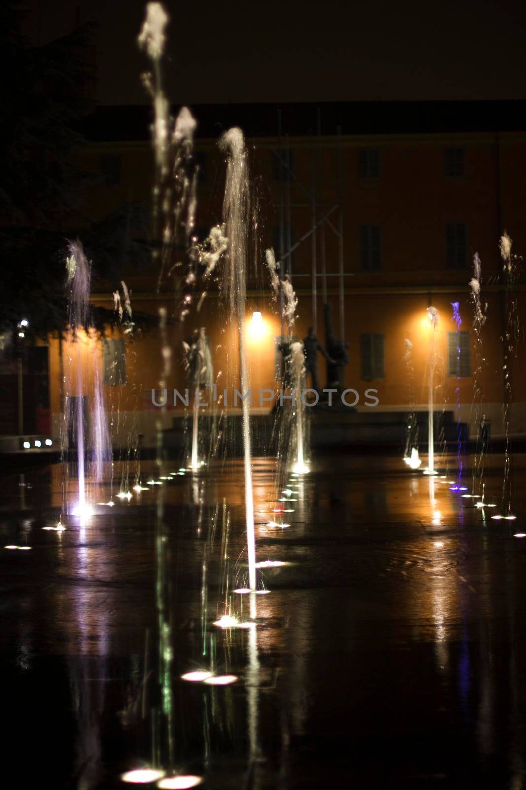 reggio emilia victory square in front of theater valleys tricolor luminous fountain. High quality photo