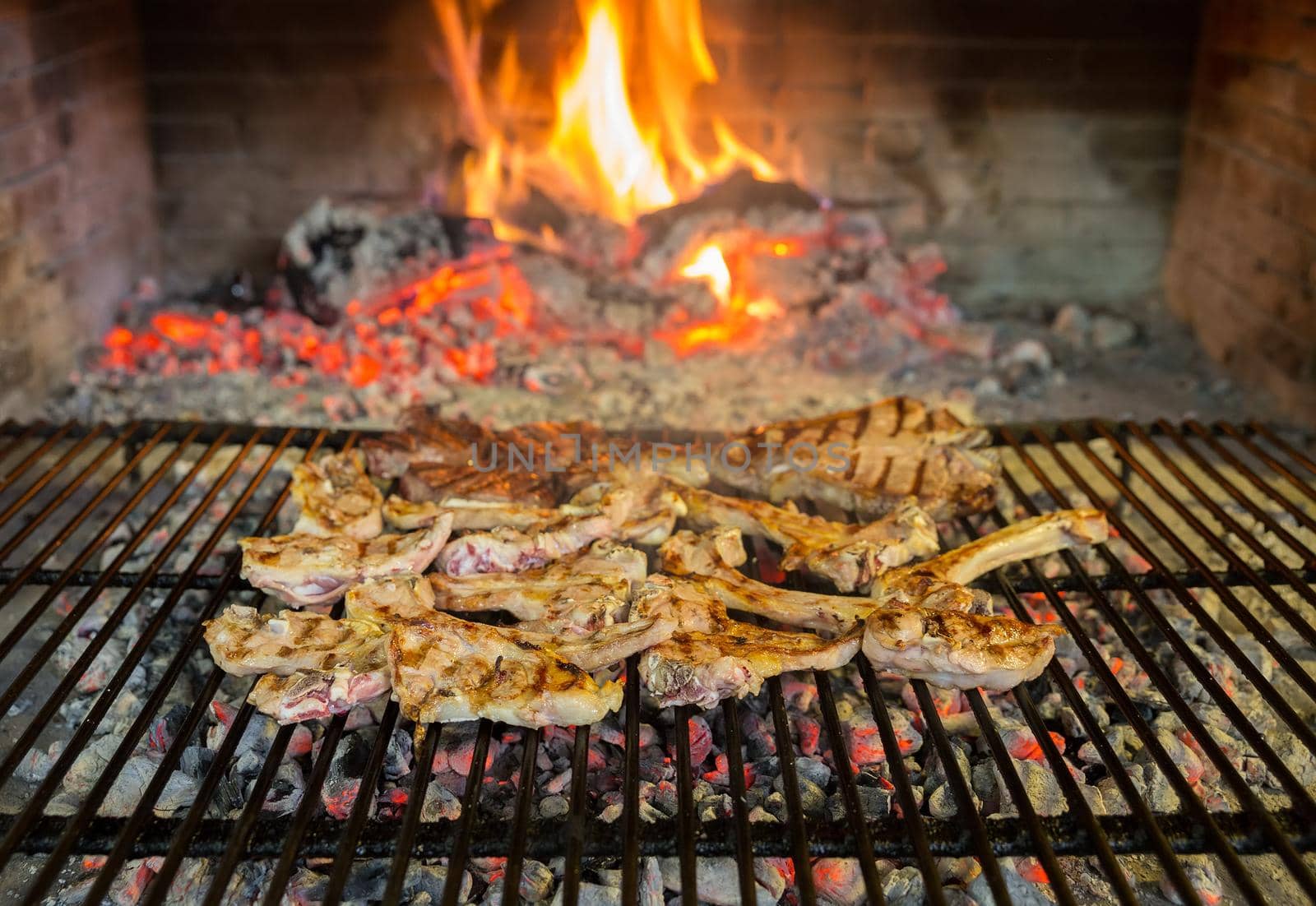 lamb chops on grill and fire, shallow depth of field