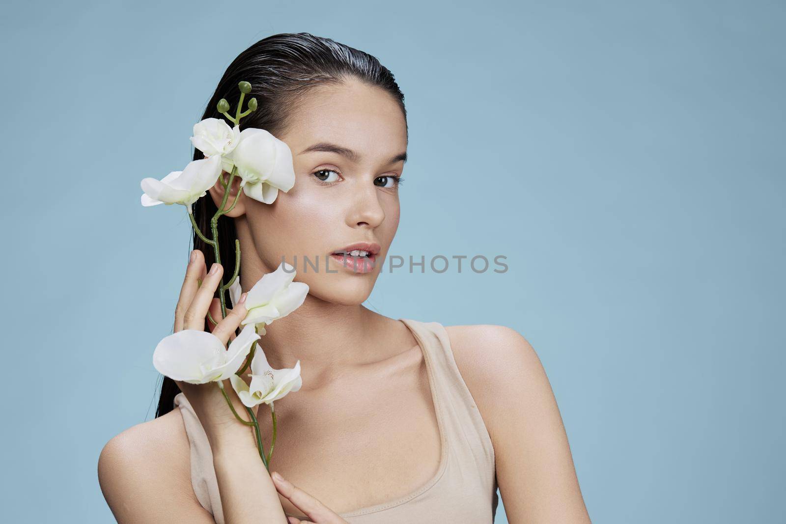 portrait woman orchid flower near face attractive look close-up Lifestyle. High quality photo