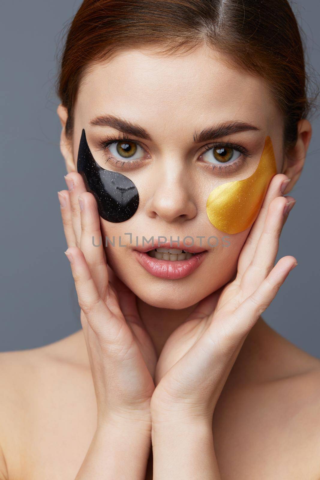 pretty woman black and gold patches on the face isolated background. High quality photo