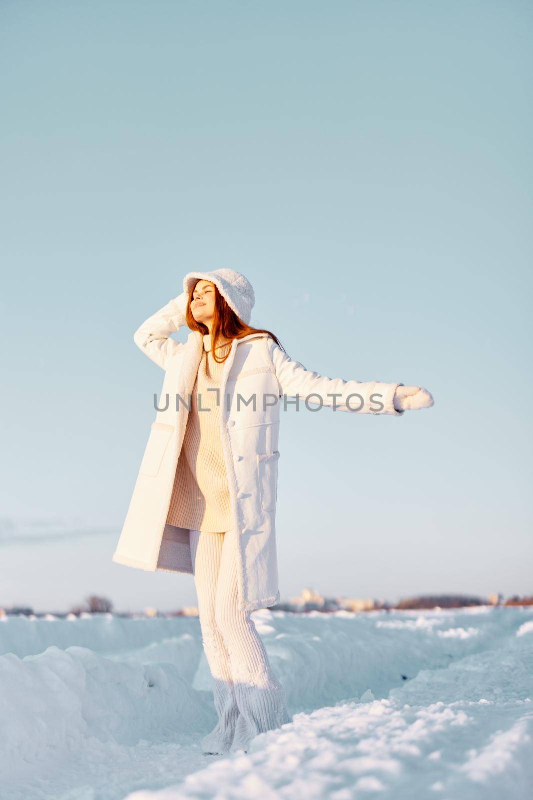beautiful woman in a white coat in a hat winter landscape walk Fresh air by SHOTPRIME