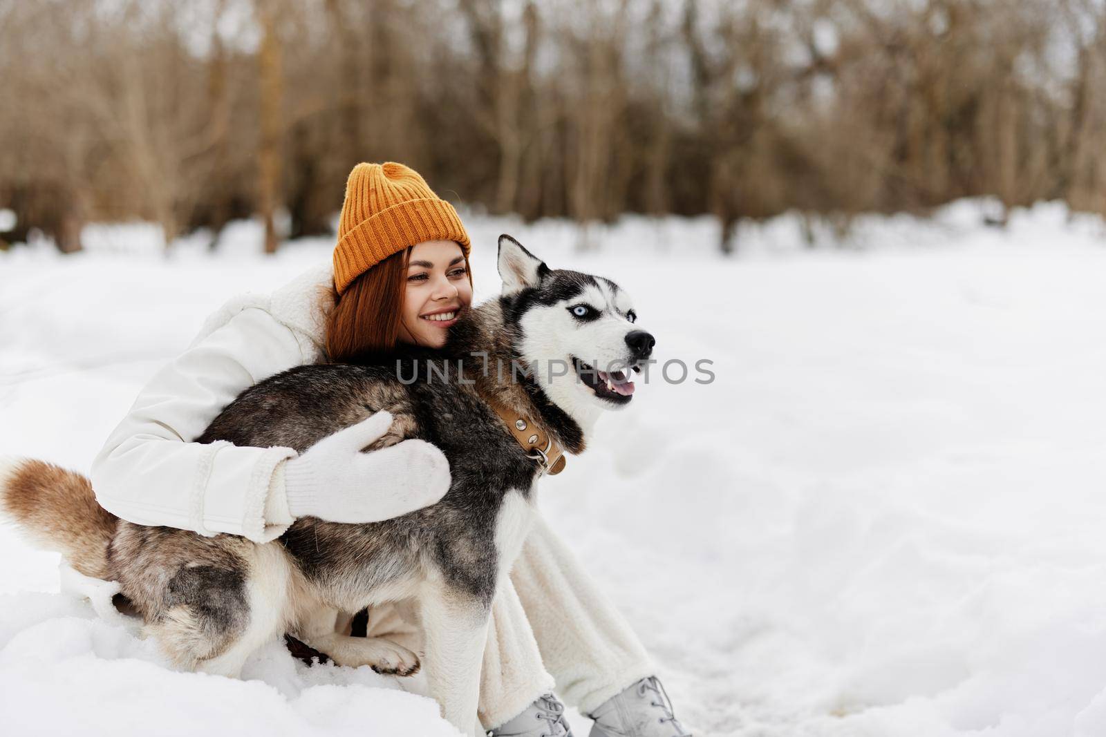 portrait of a woman outdoors in a field in winter walking with a dog Lifestyle by SHOTPRIME