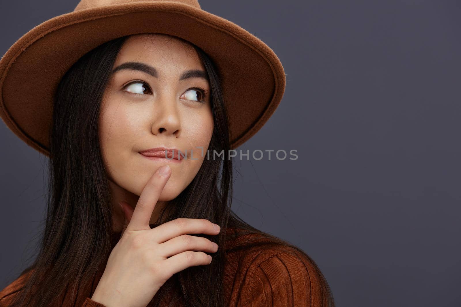 young woman brown hat hand gestures brown sweater fashion emotions isolated background. High quality photo