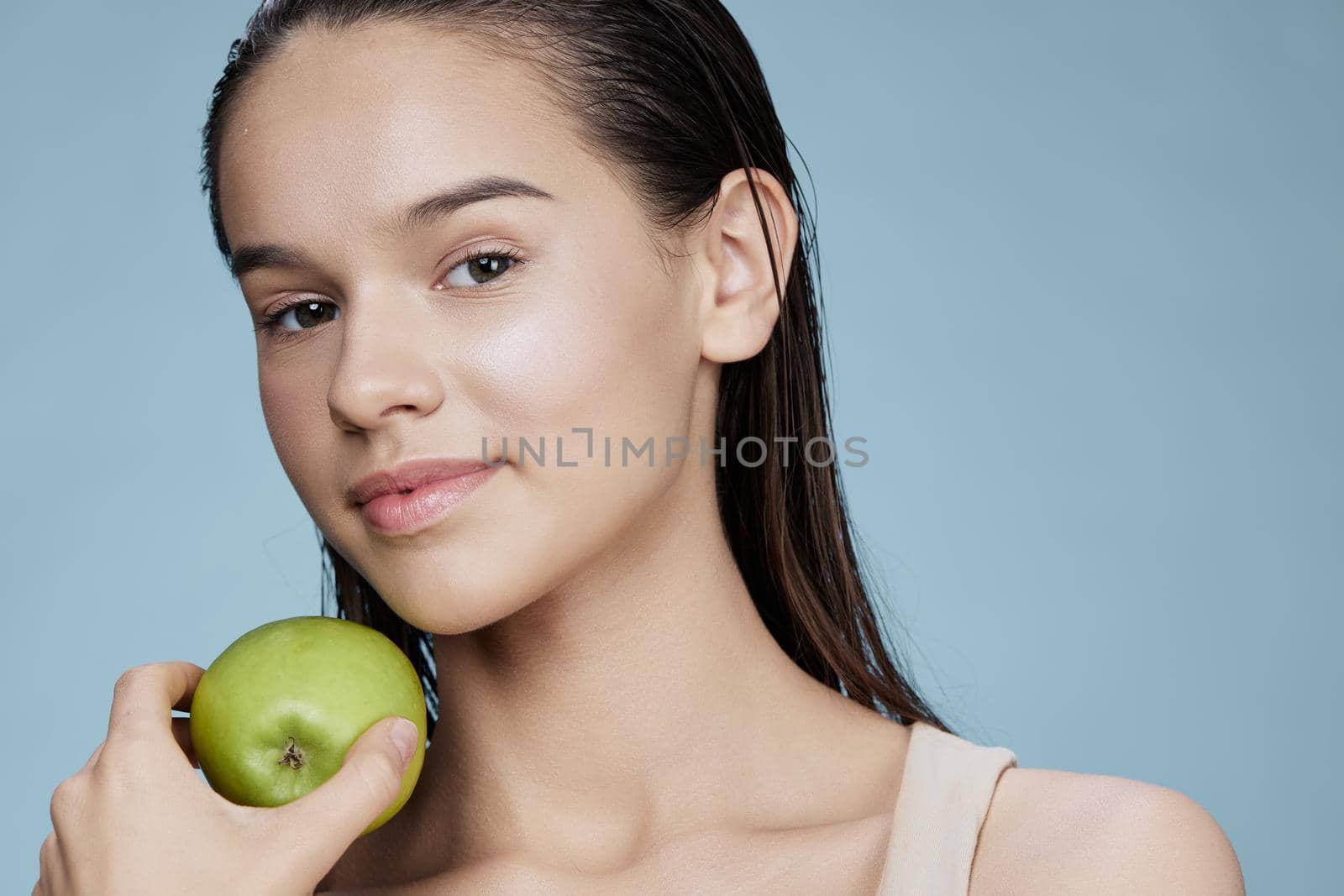 young woman green apple near face health isolated background. High quality photo