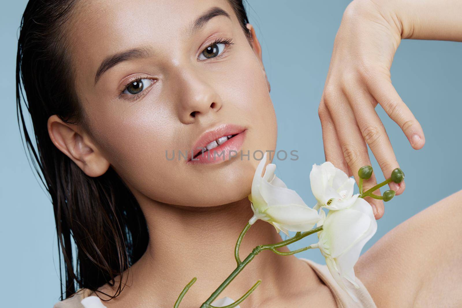 beautiful orchid flower near face attractive look isolated background by SHOTPRIME