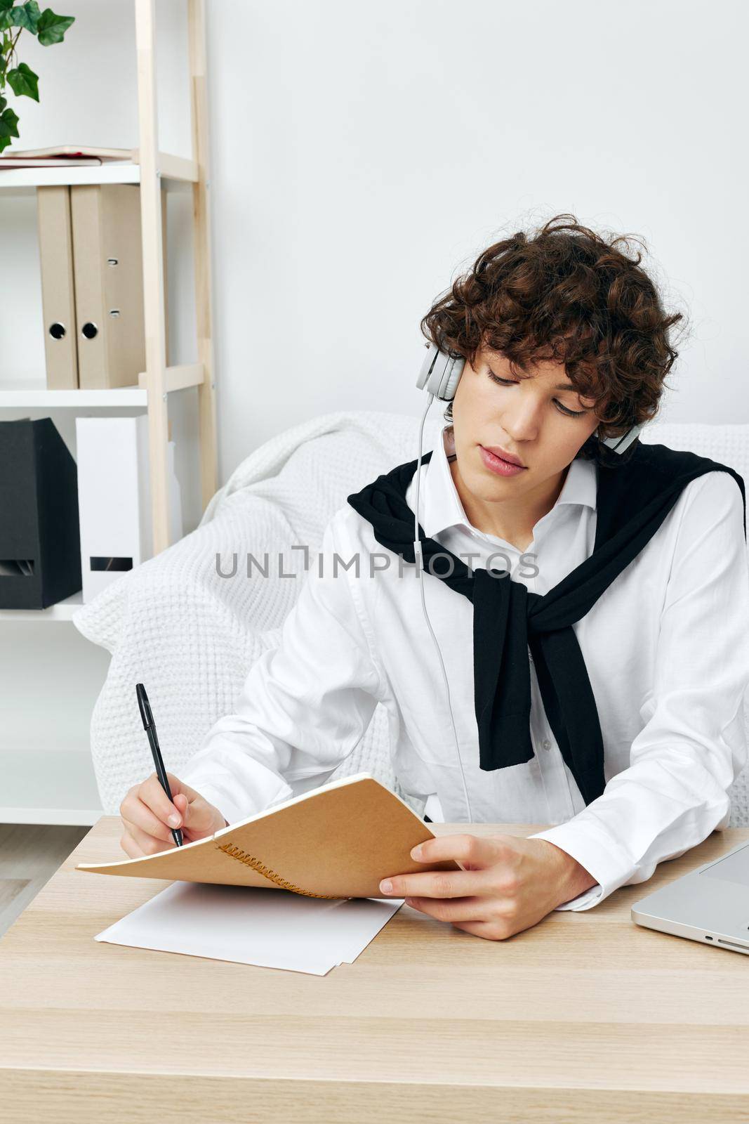 guy does homework on the couch communication. High quality photo