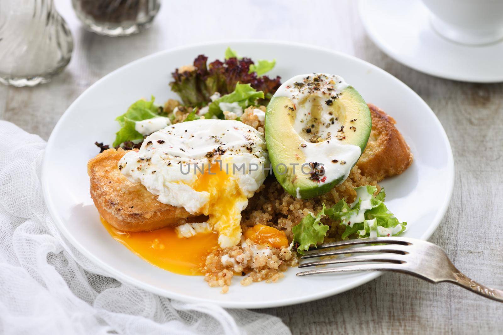 A healthy and balanced breakfast plate.
Benedict's egg spreads on a toasted toast with half an avocado, quinoa and lettuce, seasoned   spices and yogurt dressing. Enjoy the most important meal of the day
