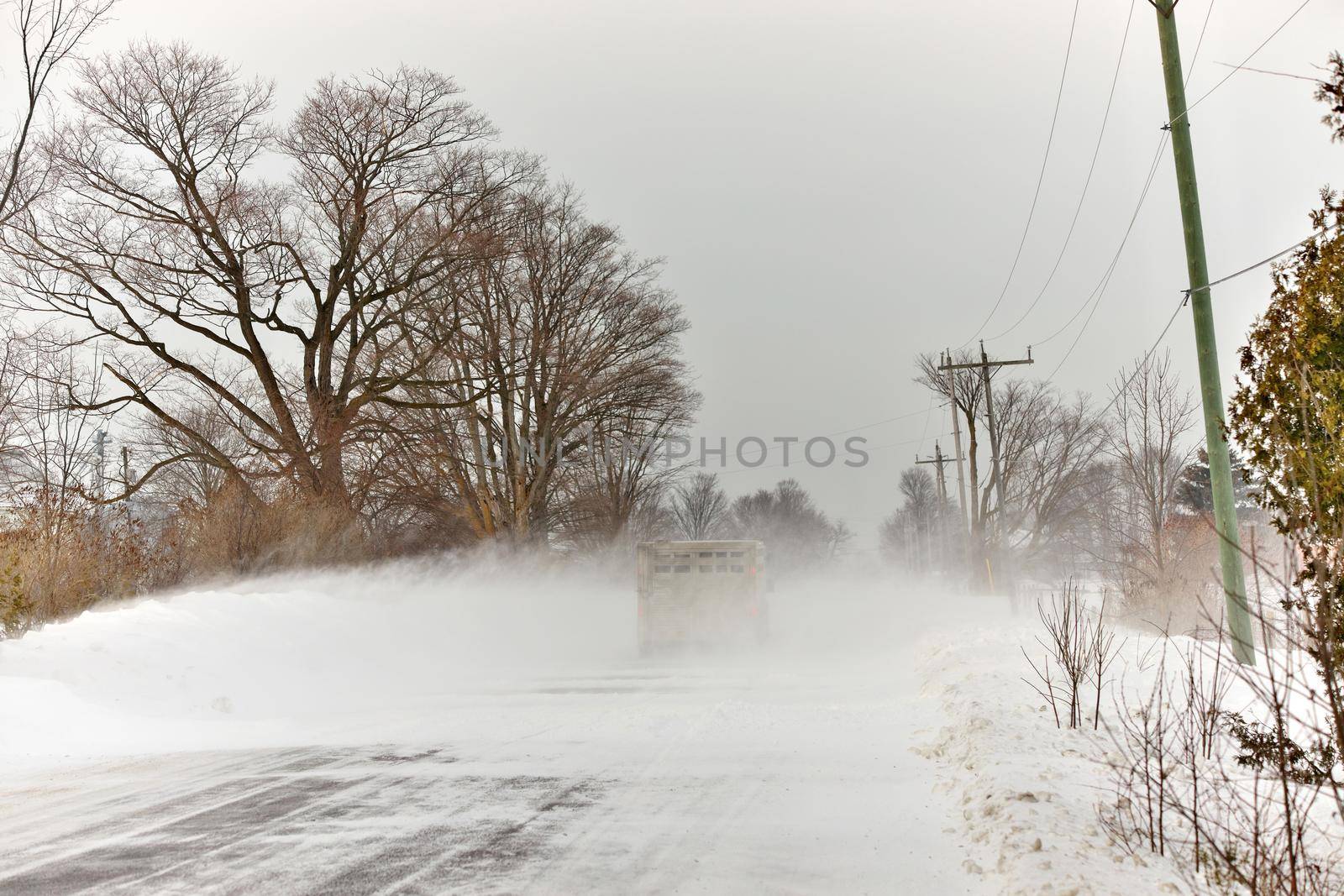 Snow Squall Conditions on a Country Road in Ontario Canada by markvandam