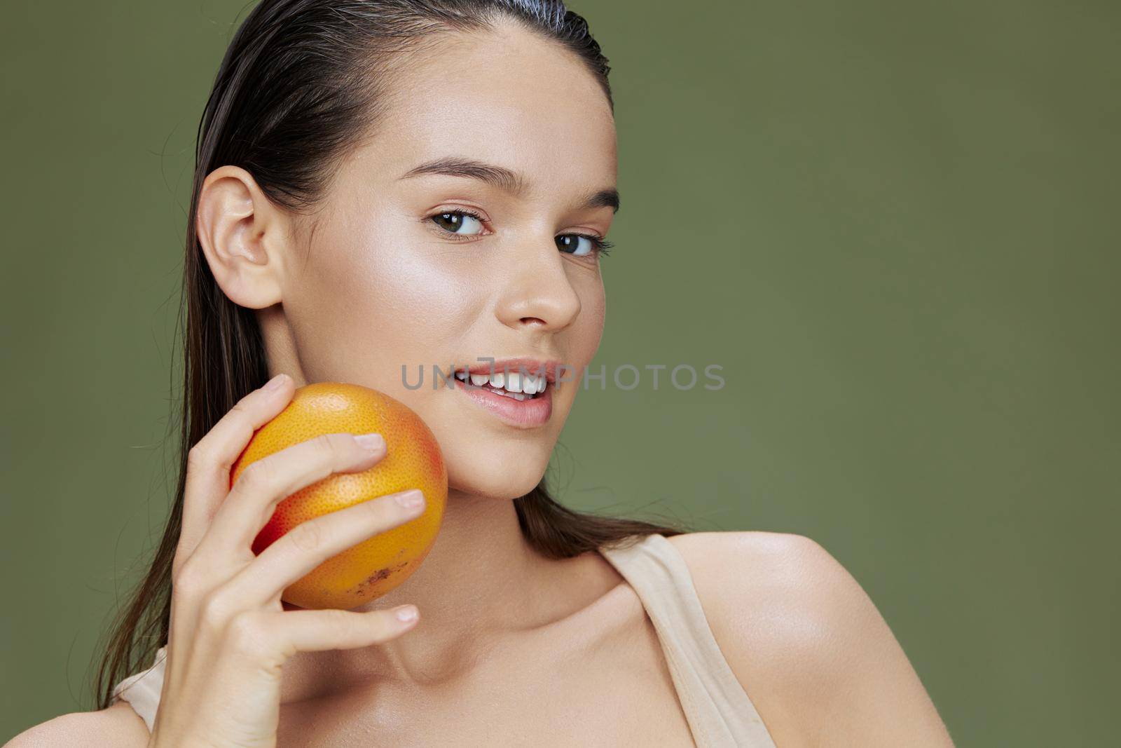 beautiful woman eating grapefruit in hands smile vitamins diet close-up Lifestyle. High quality photo