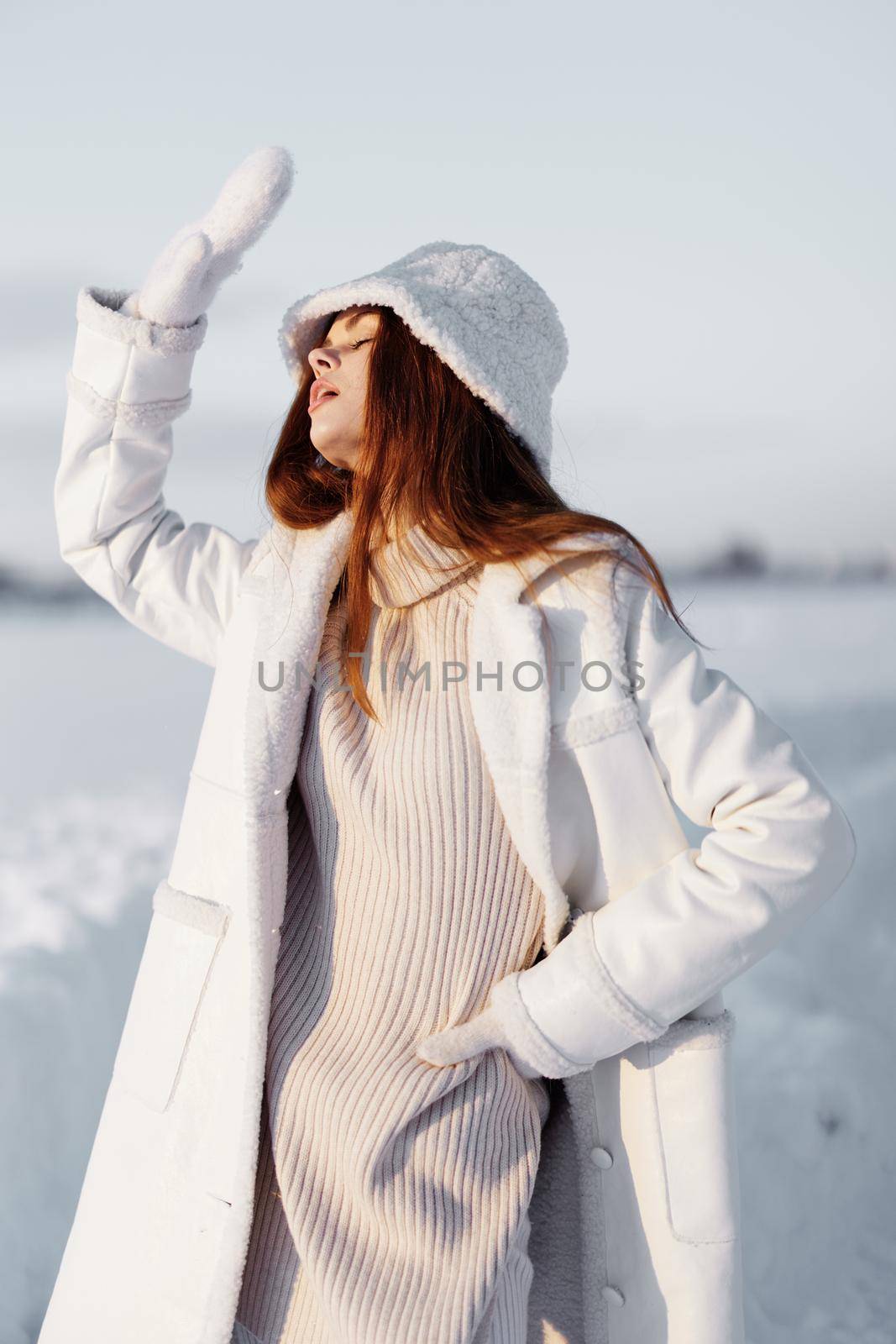 young woman smile Winter mood walk white coat nature. High quality photo