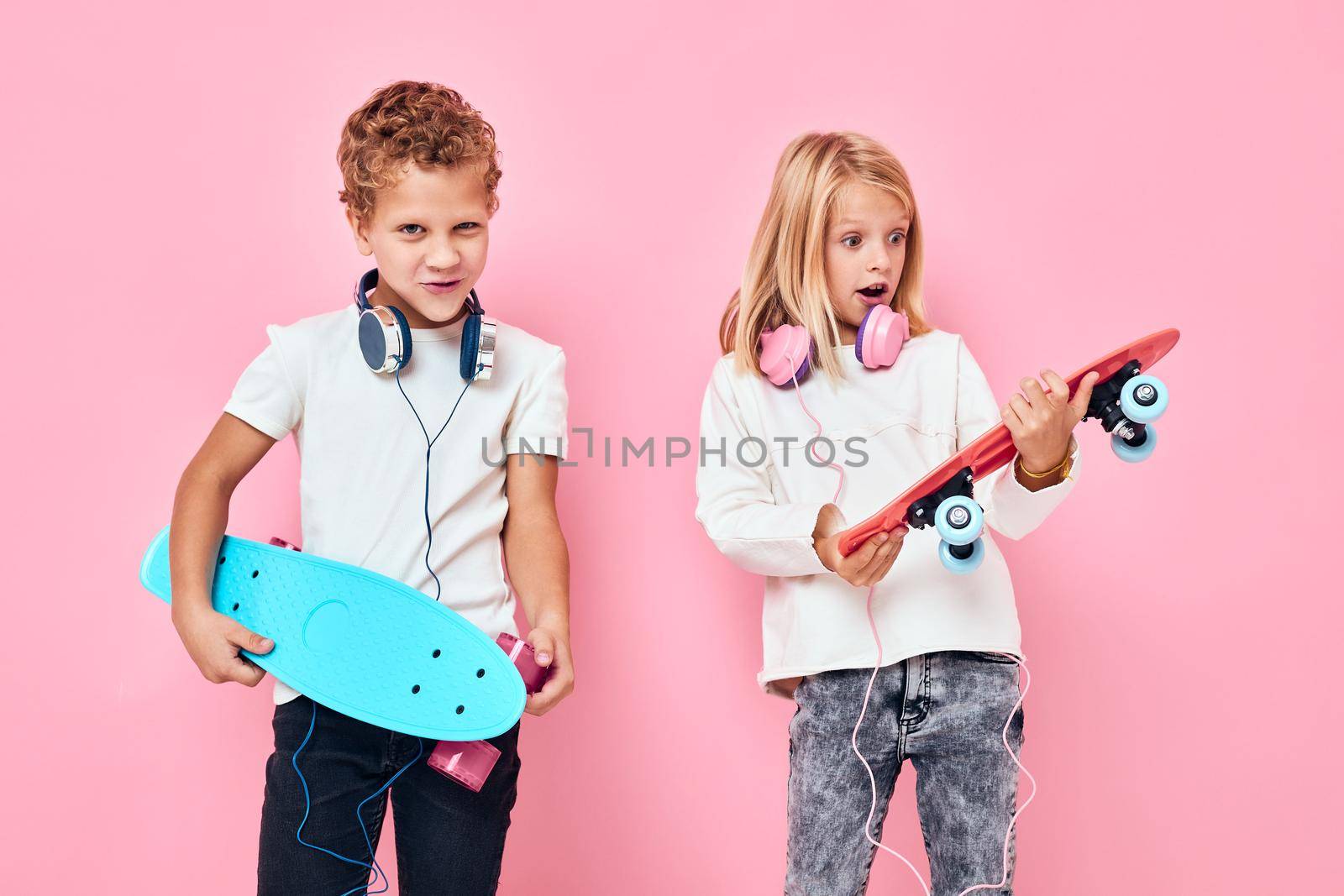 Children riding skateboard in headphones skateboards in hands active lifestyle childhood. High quality photo