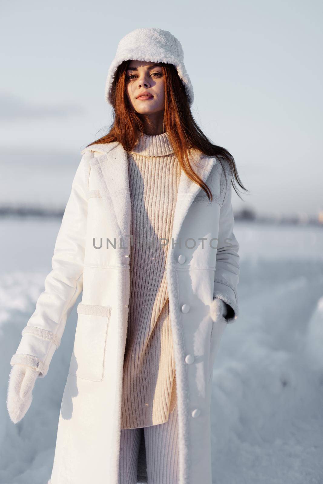 beautiful woman in a white coat in a hat winter landscape walk travel by SHOTPRIME