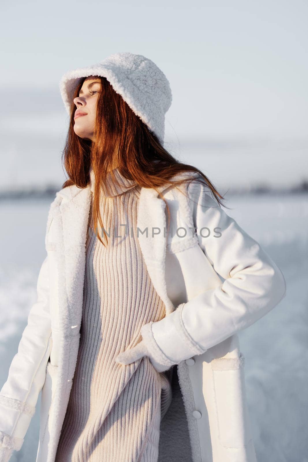 woman red hair snow field winter clothes nature. High quality photo