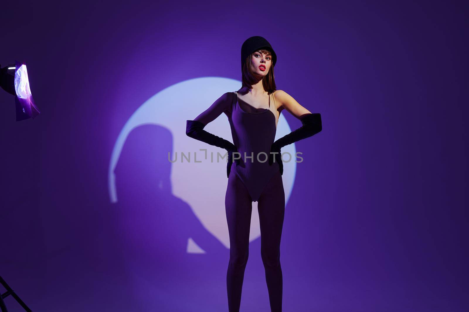 Pretty young female scene spotlight posing neon purple background unaltered by SHOTPRIME