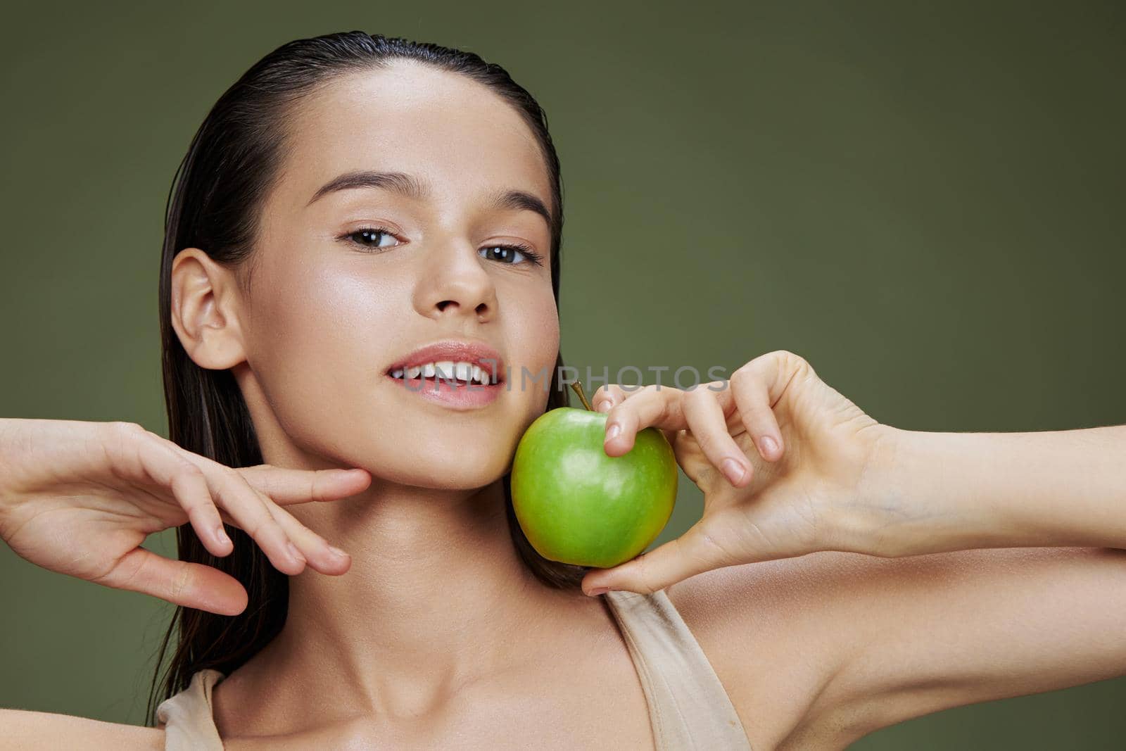brunette green apple near face health isolated background by SHOTPRIME